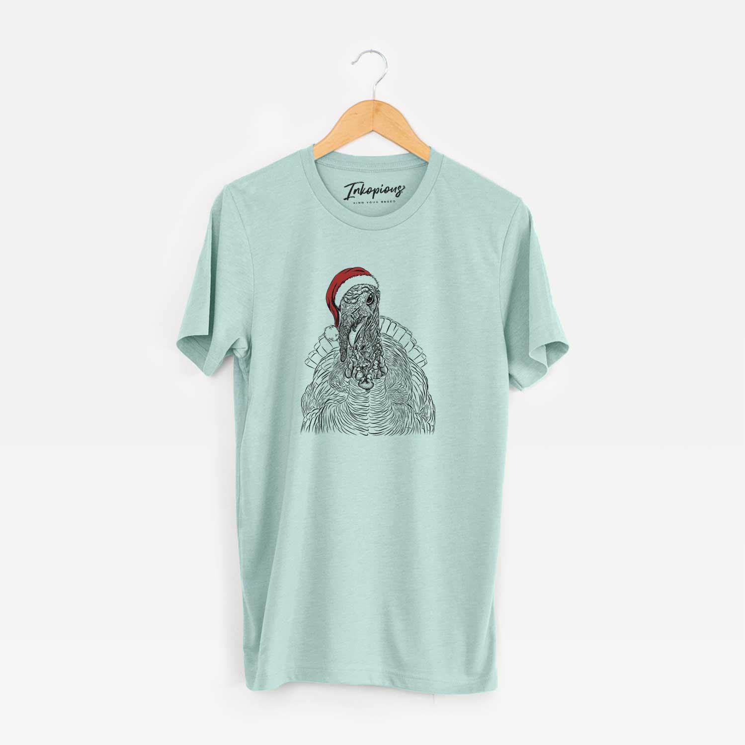 Hand-drawn sketch of Brady the Turkey wearing a Santa hat on a Heather Sage Unisex crewneck