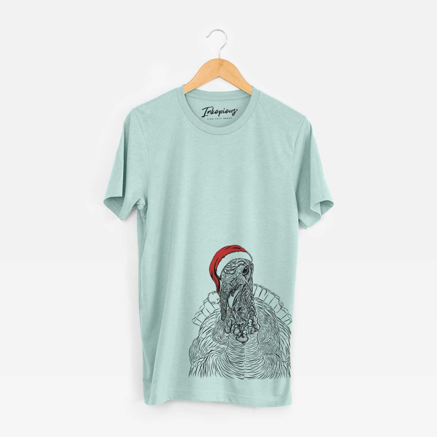 Hand-drawn sketch of Brady the Turkey wearing a Santa hat on a Heather Sage Unisex crewneck