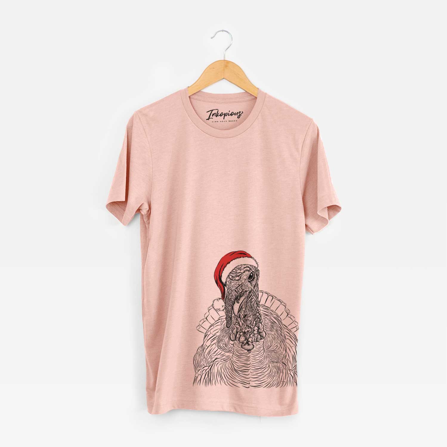 Hand-drawn sketch of Brady the Turkey wearing a Santa hat on a Peach Unisex crewneck