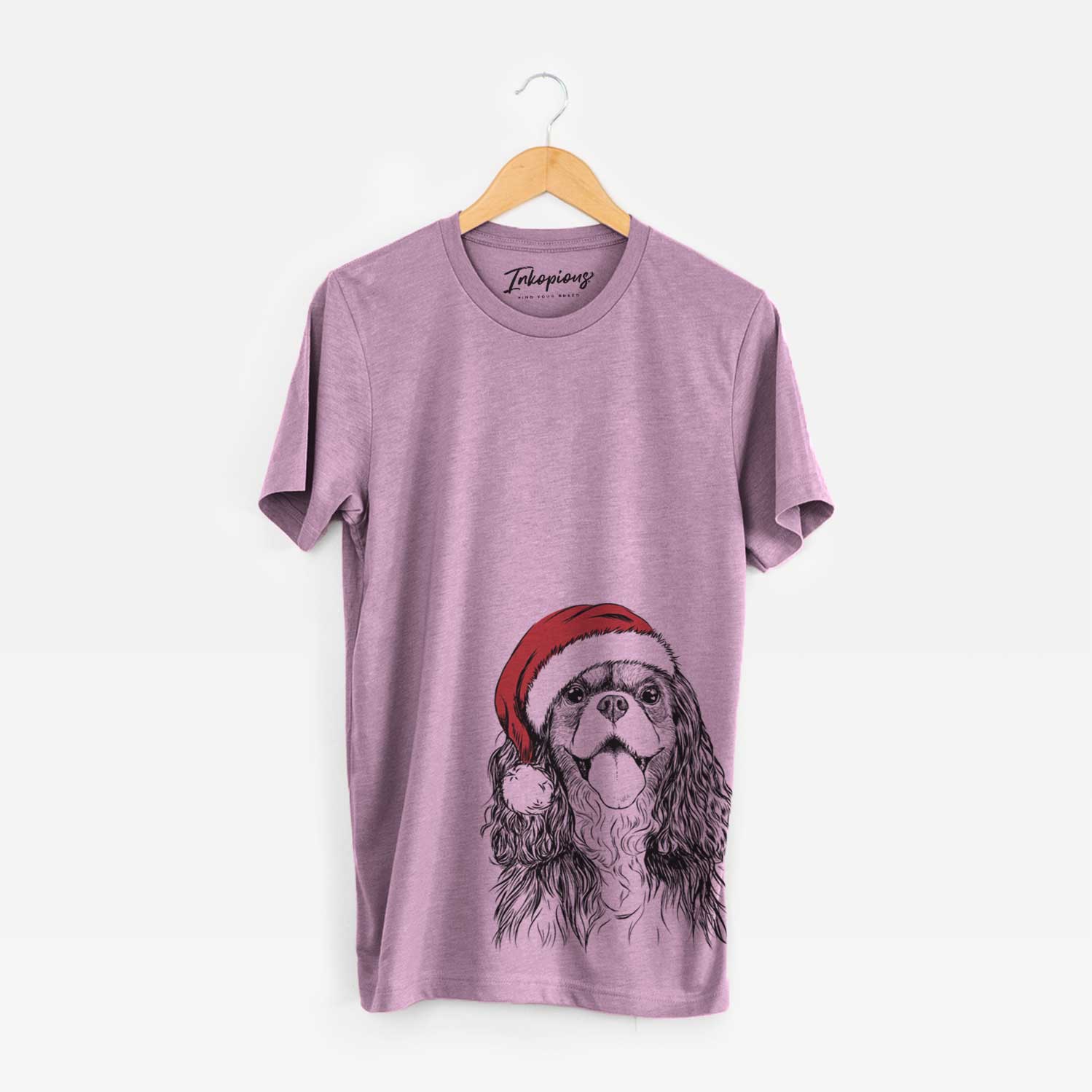 Hand-drawn sketch of Brandy the Cavalier King Charles Spaniel wearing a Santa hat on an Orchid Unisex crewneck