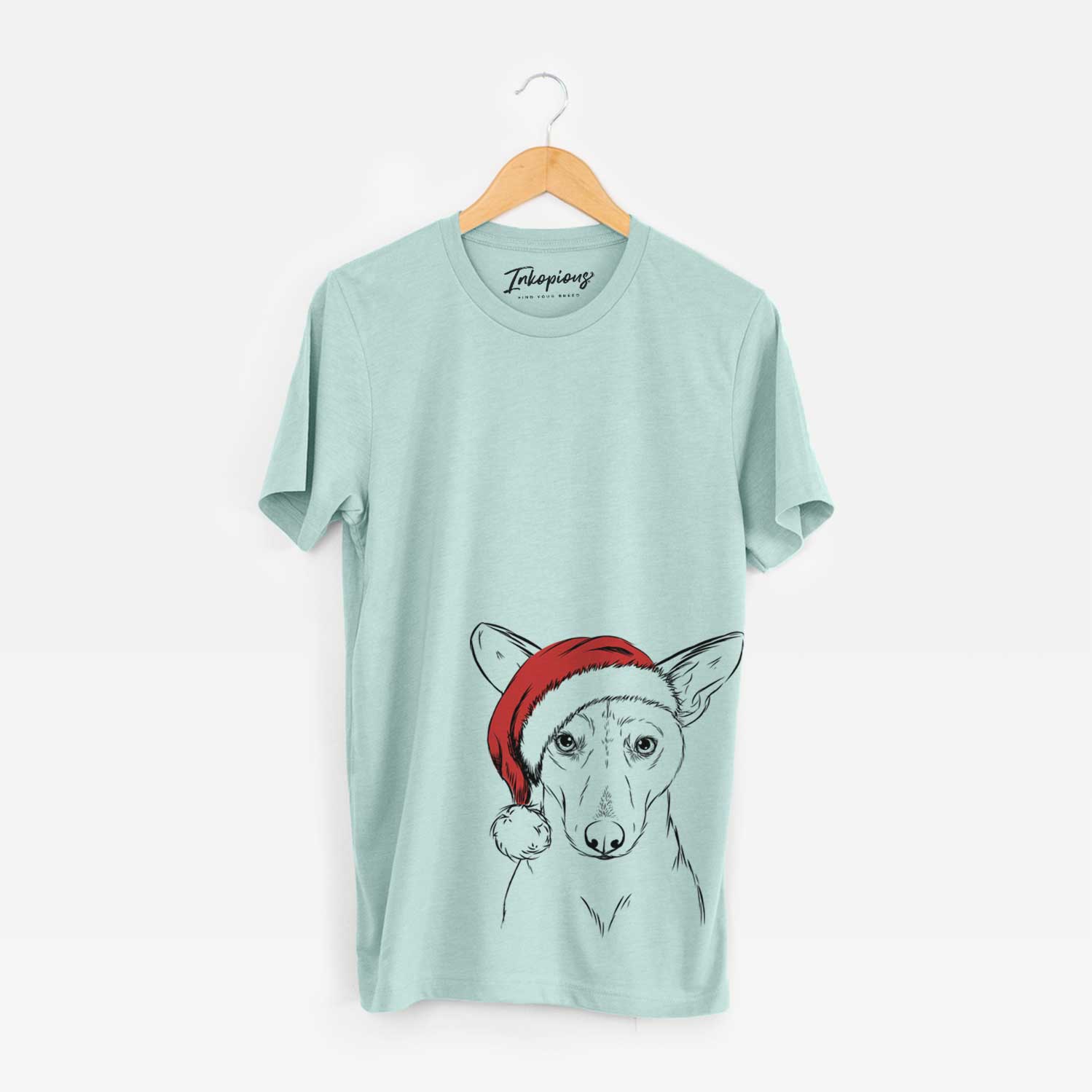 Hand-drawn sketch of Buff the Dorgi wearing a Santa hat on a Heather Sage Unisex crewneck
