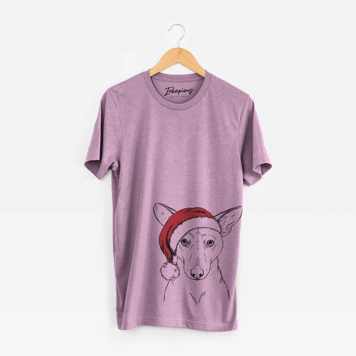 Hand-drawn sketch of Buff the Dorgi wearing a Santa hat on an Orchid Unisex crewneck