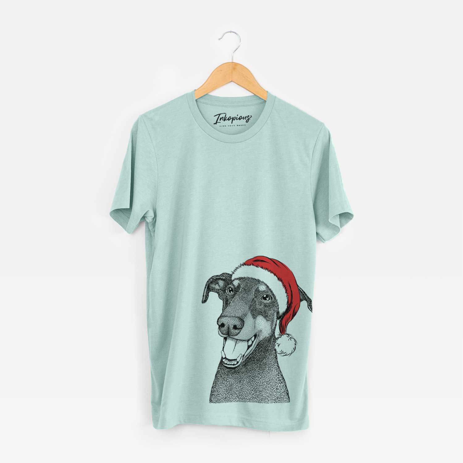 Hand-drawn sketch of Bunnie the Doberman Pinscher wearing a Santa hat on a Heather Sage Unisex crewneck