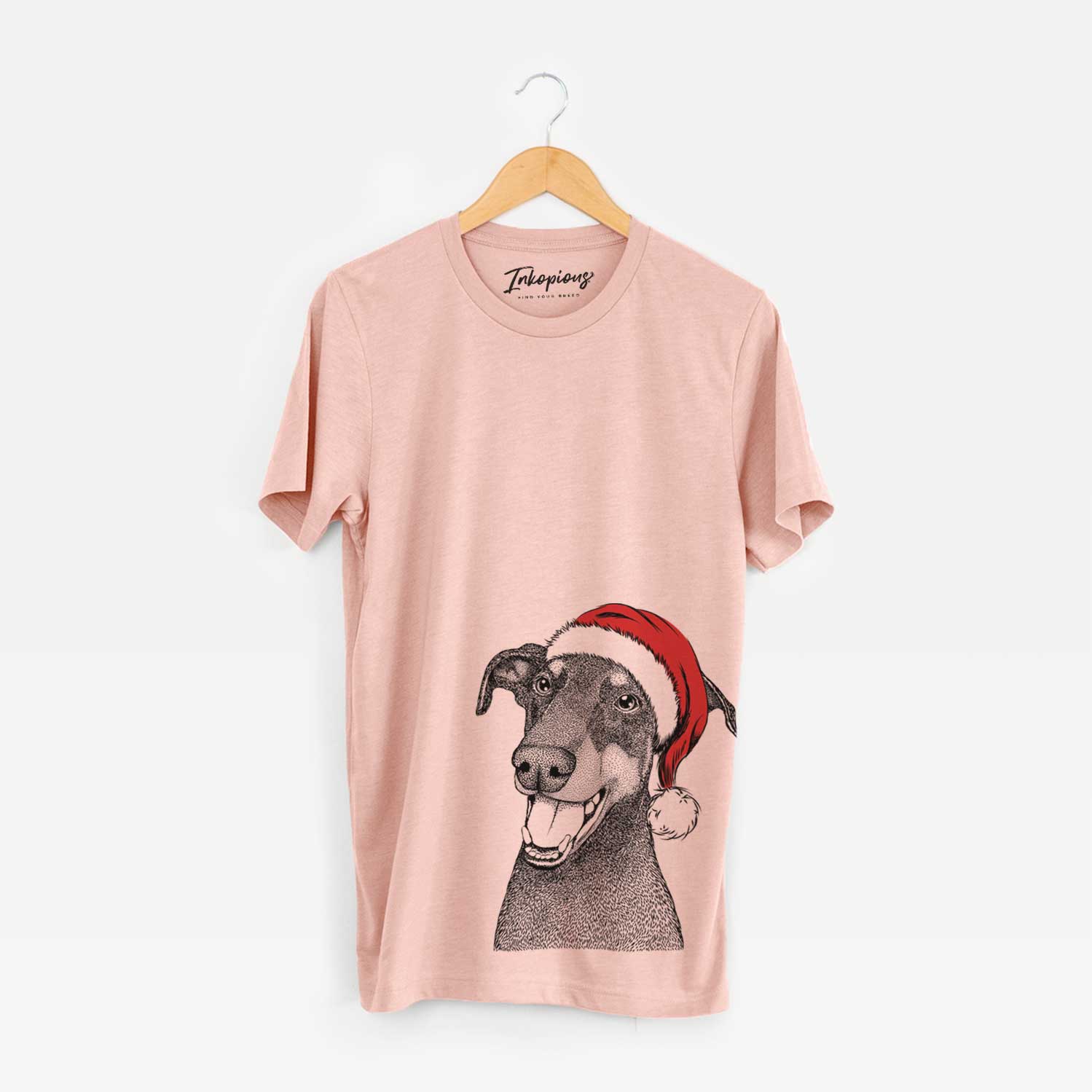 Hand-drawn sketch of Bunnie the Doberman Pinscher wearing a Santa hat on a Peach Unisex crewneck