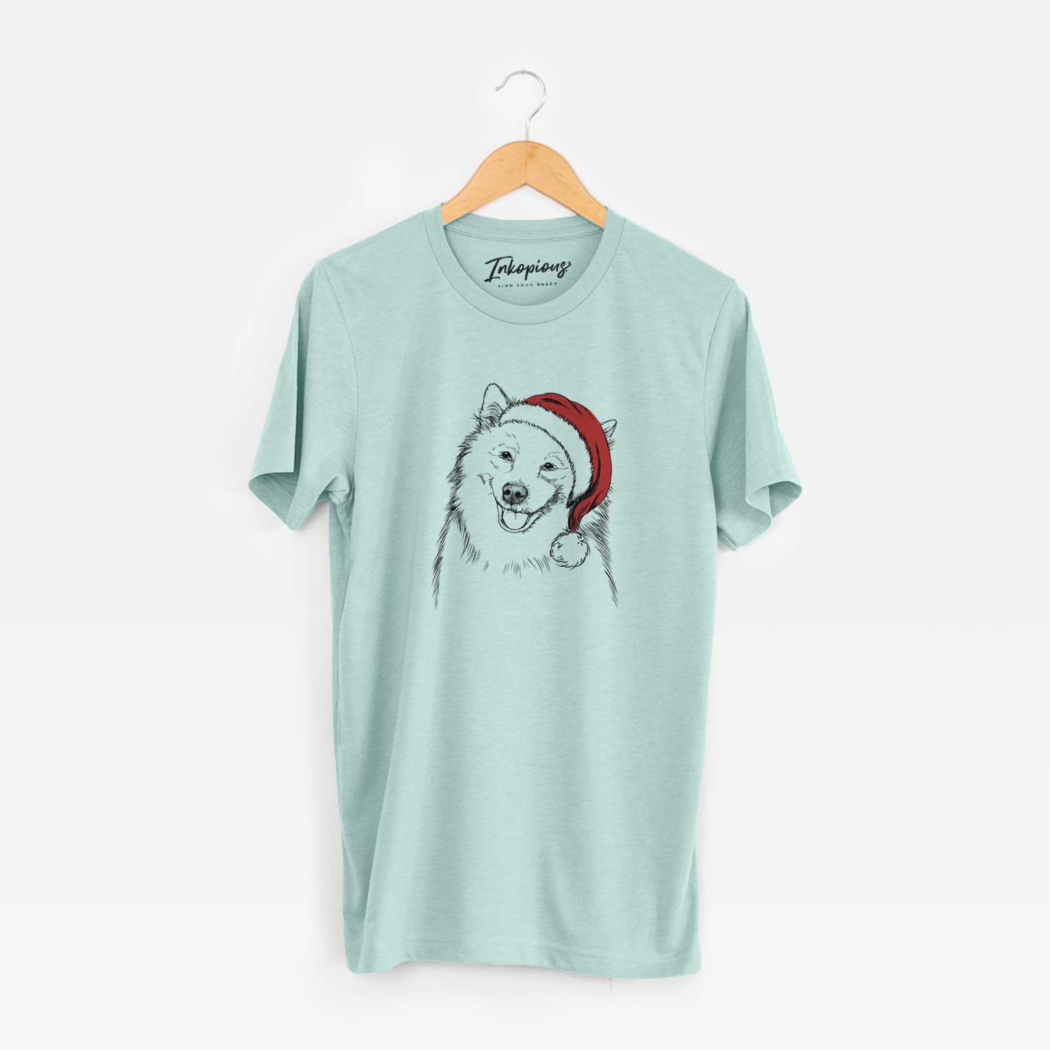 Hand-drawn sketch of Caico the Samoyed wearing a Santa hat on a Heather Sage Unisex crewneck