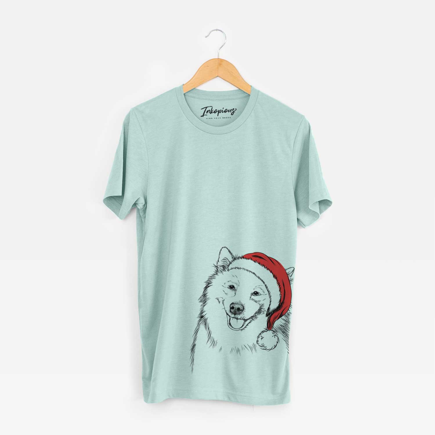 Hand-drawn sketch of Caico the Samoyed wearing a Santa hat on a Heather Sage Unisex crewneck