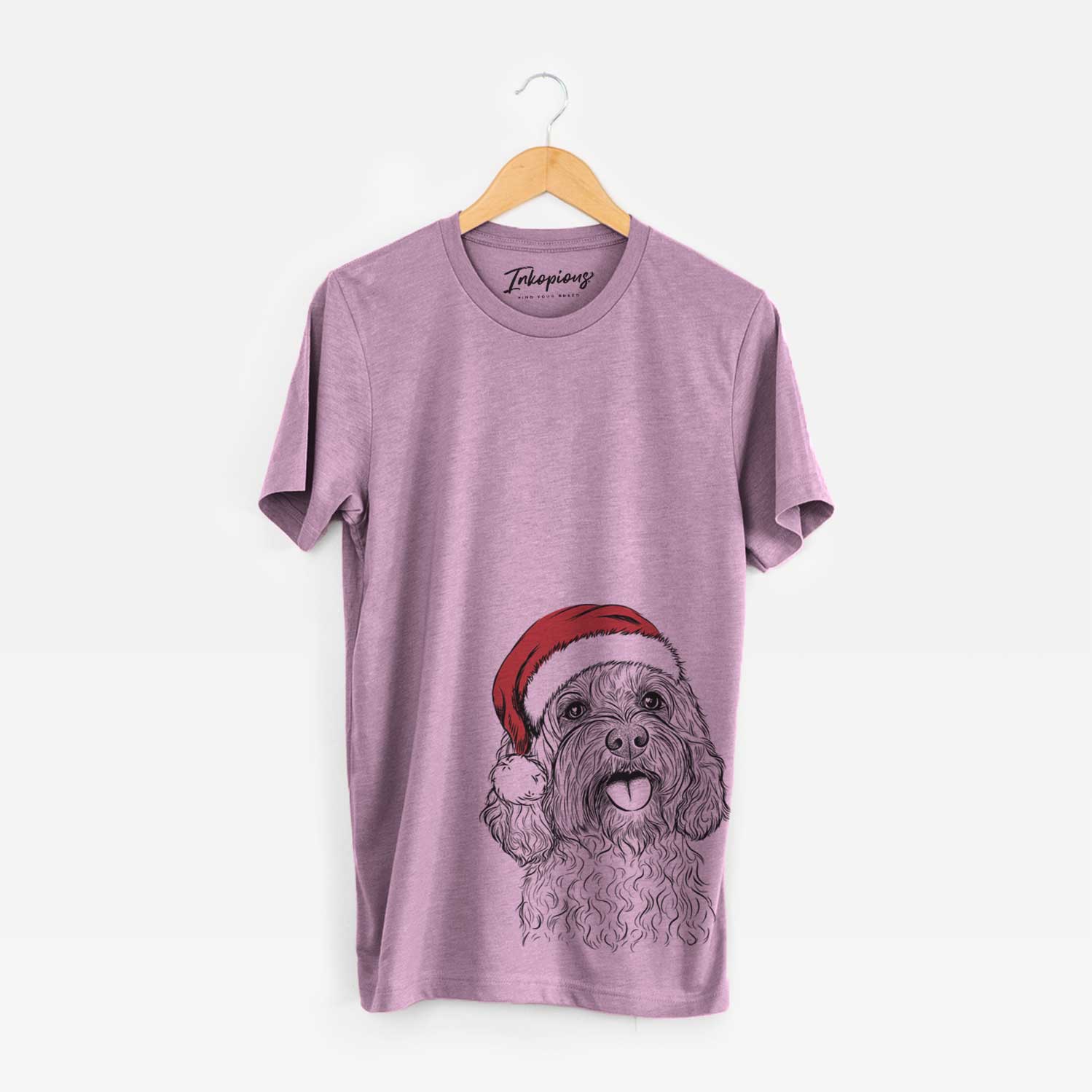Hand-drawn sketch of Cali the Cavapoo wearing a Santa hat on an Orchid Unisex crewneck
