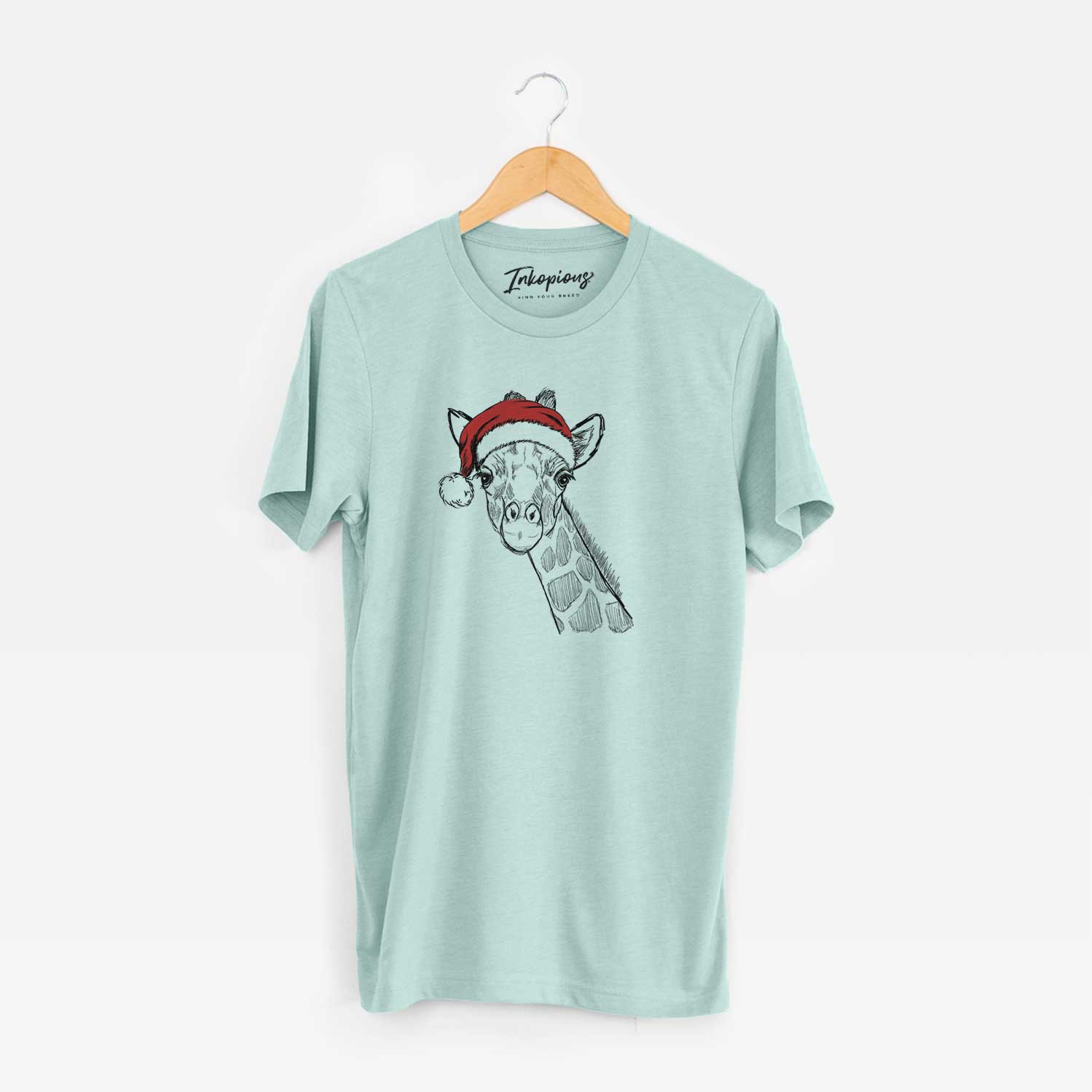 Hand-drawn sketch of Cedrick the Giraffe wearing a Santa hat on a Heather Sage Unisex crewneck