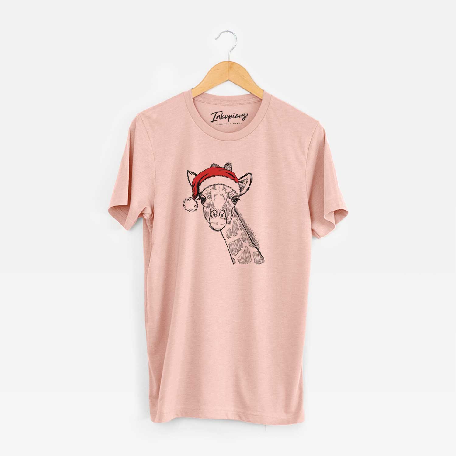 Hand-drawn sketch of Cedrick the Giraffe wearing a Santa hat on a Peach Unisex crewneck