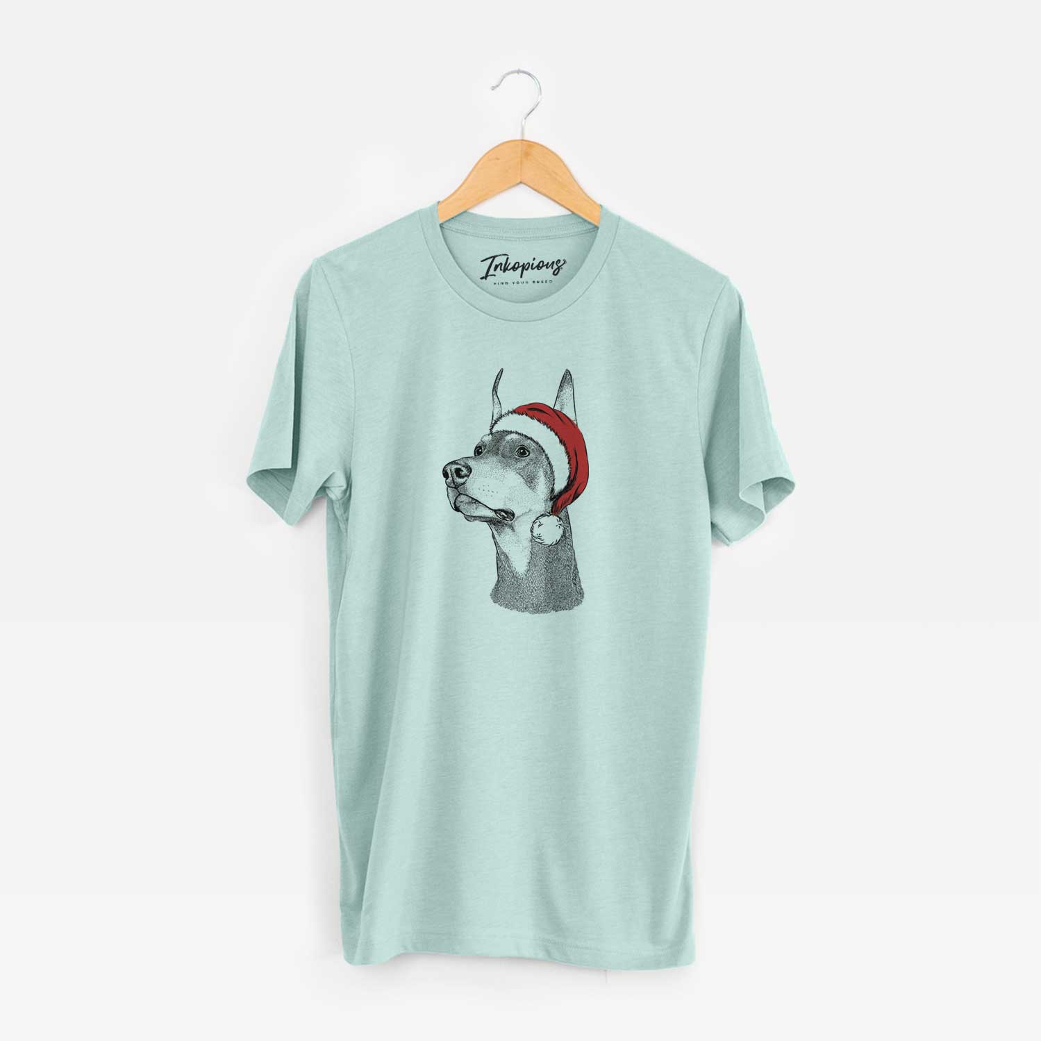 Hand-drawn sketch of Cenza the Doberman Pinscher wearing a Santa hat on a Heather Sage Unisex crewneck