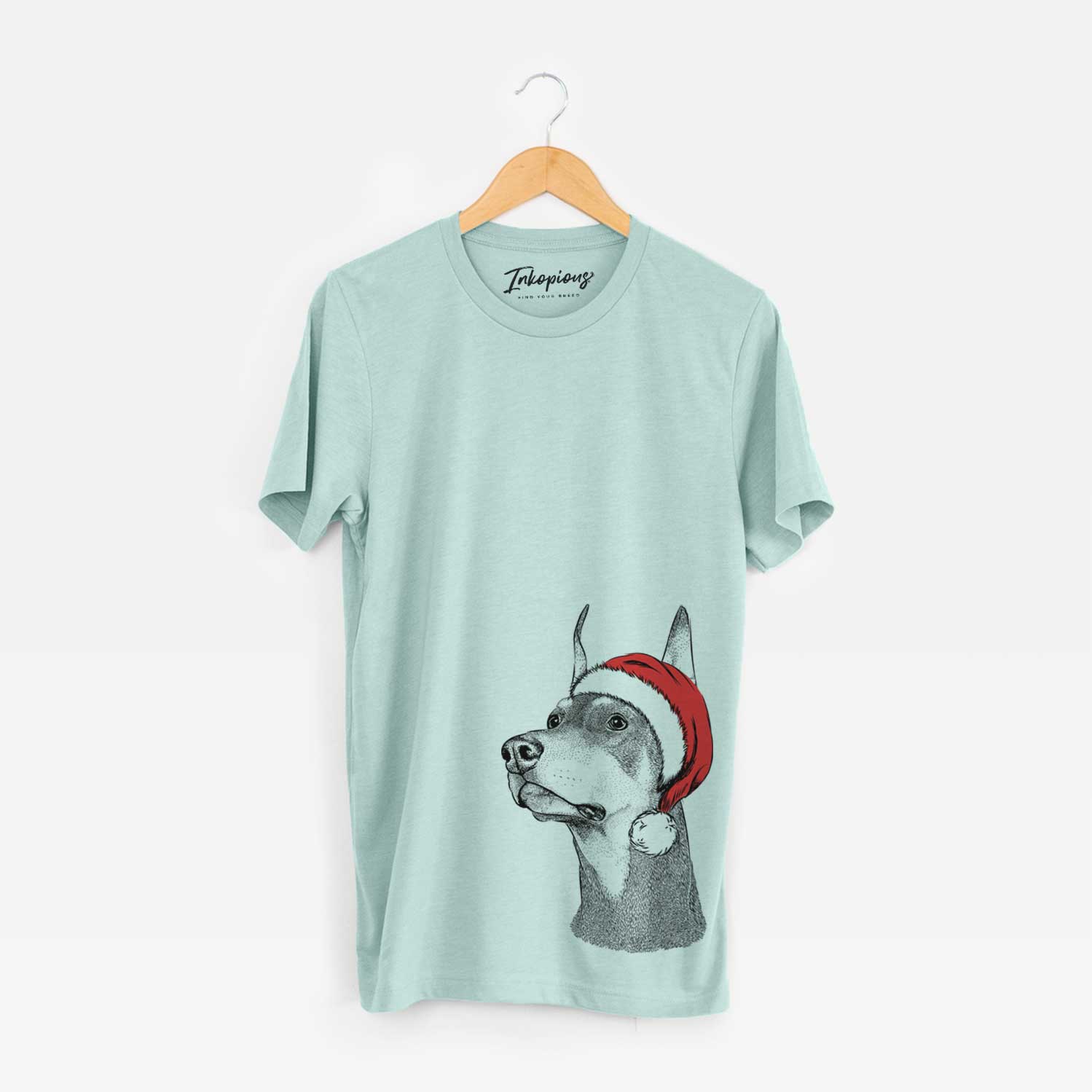 Hand-drawn sketch of Cenza the Doberman Pinscher wearing a Santa hat on a Heather Sage Unisex crewneck