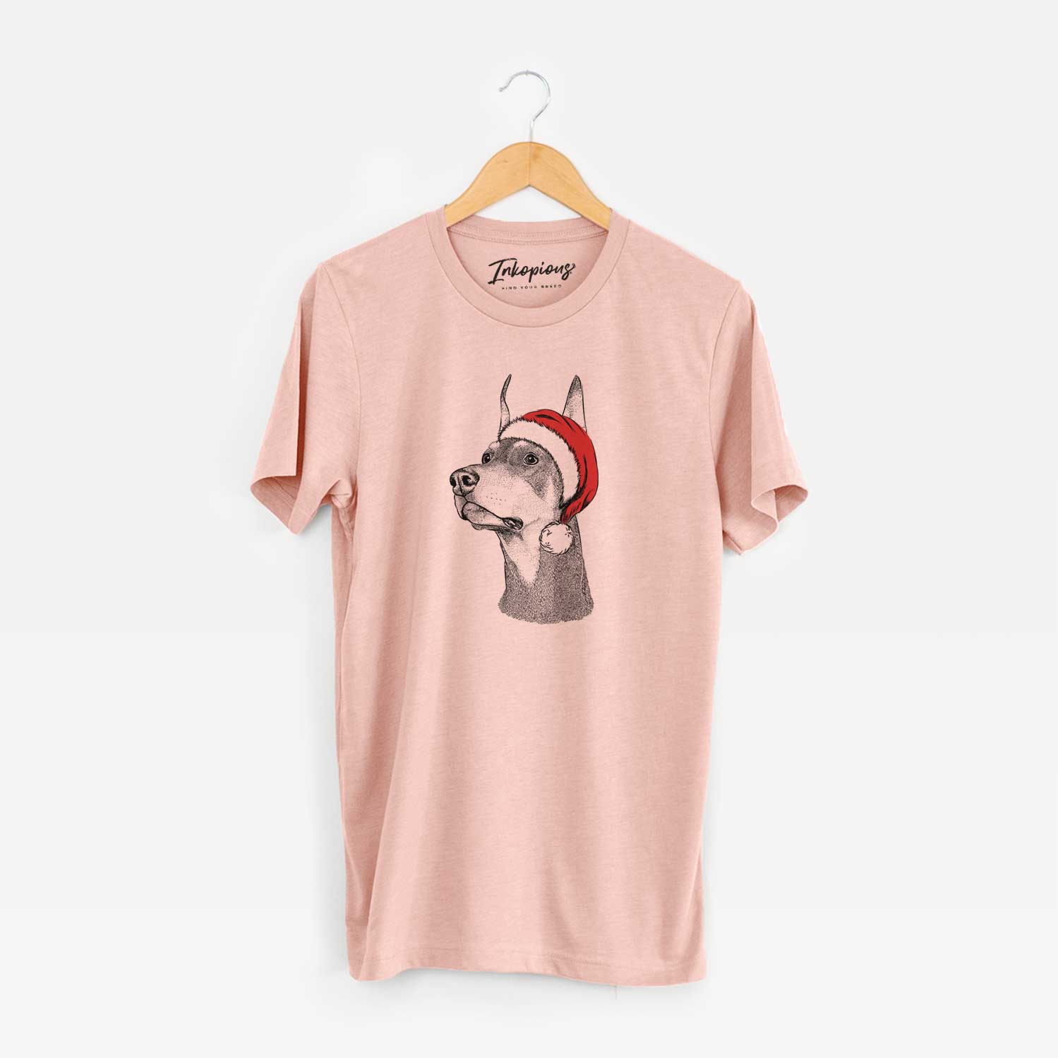 Hand-drawn sketch of Cenza the Doberman Pinscher wearing a Santa hat on a Peach Unisex crewneck
