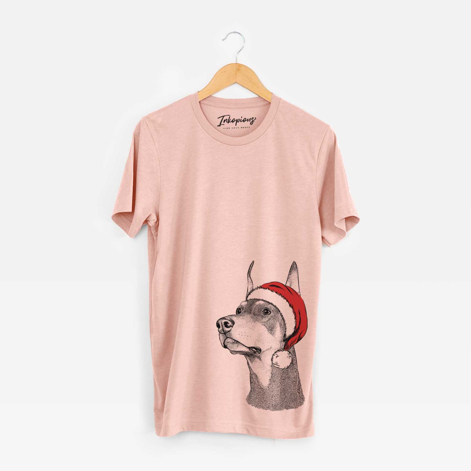 Hand-drawn sketch of Cenza the Doberman Pinscher wearing a Santa hat on a Peach Unisex crewneck
