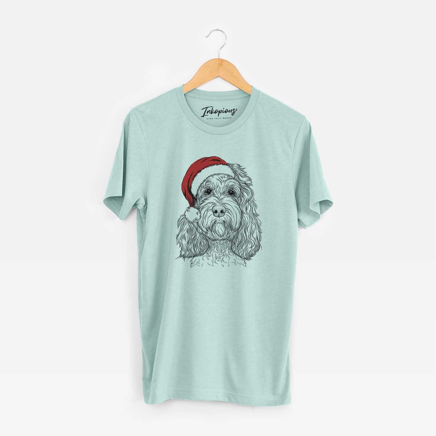 Hand-drawn sketch of Chloe the Cockapoo wearing a Santa hat on a Heather Sage Unisex crewneck