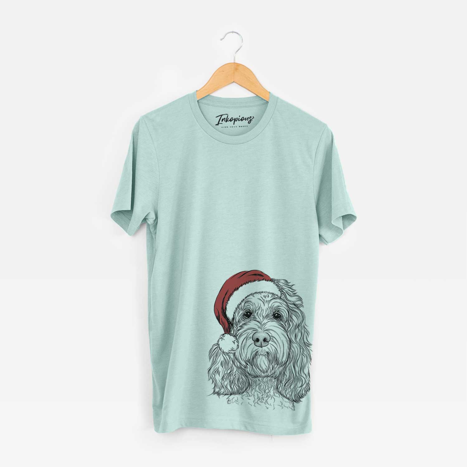 Hand-drawn sketch of Chloe the Cockapoo wearing a Santa hat on a Heather Sage Unisex crewneck