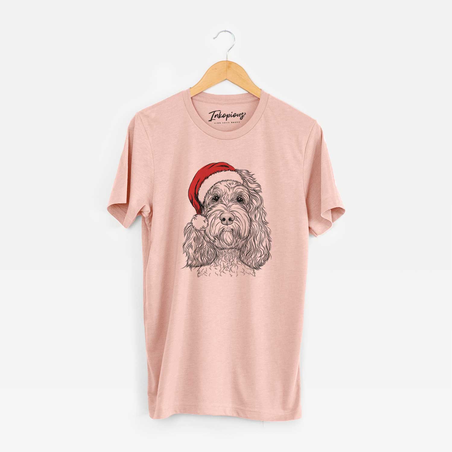 Hand-drawn sketch of Chloe the Cockapoo wearing a Santa hat on a Peach Unisex crewneck