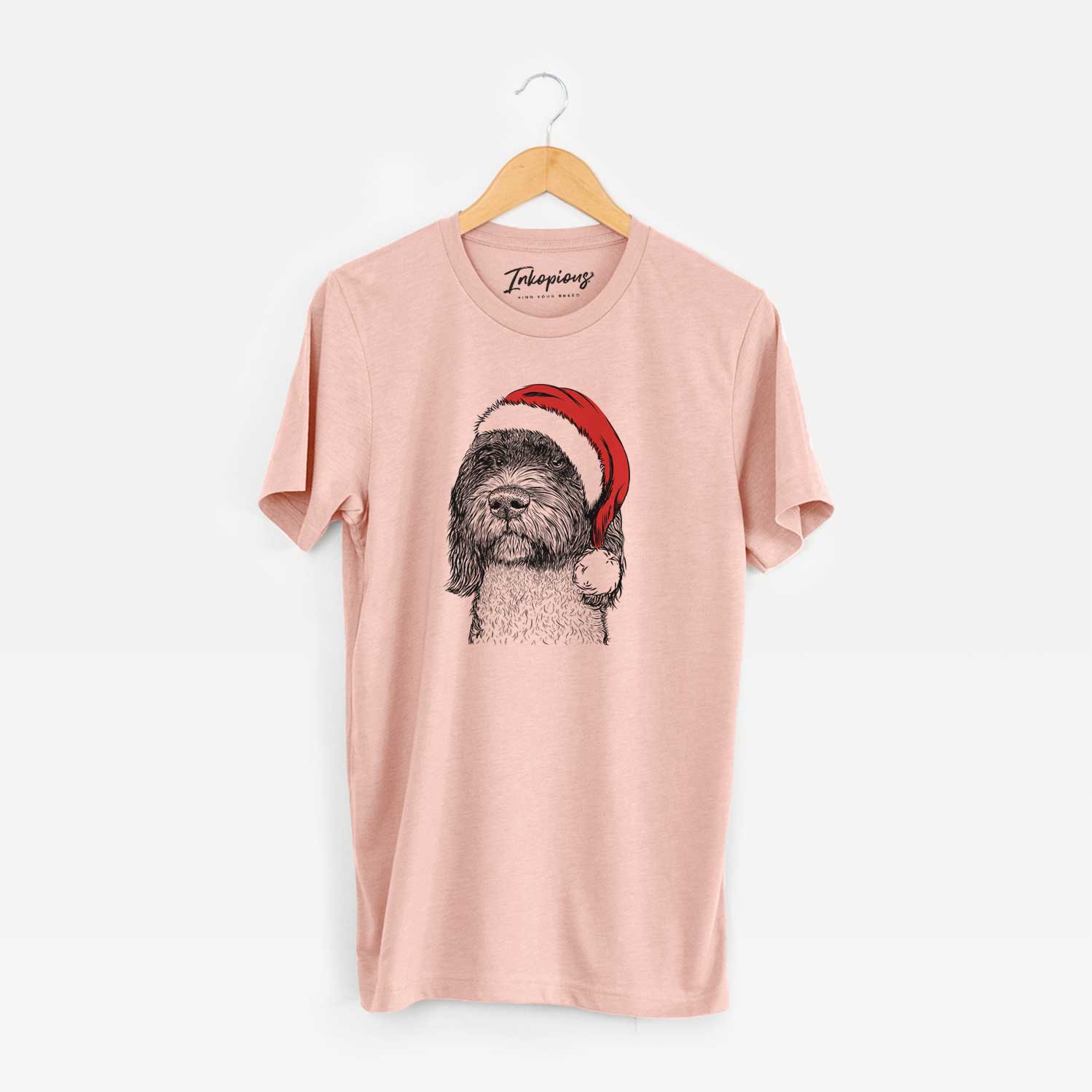 Hand-drawn sketch of Chris the Portuguese Water Dog wearing a Santa hat on a Peach Unisex crewneck