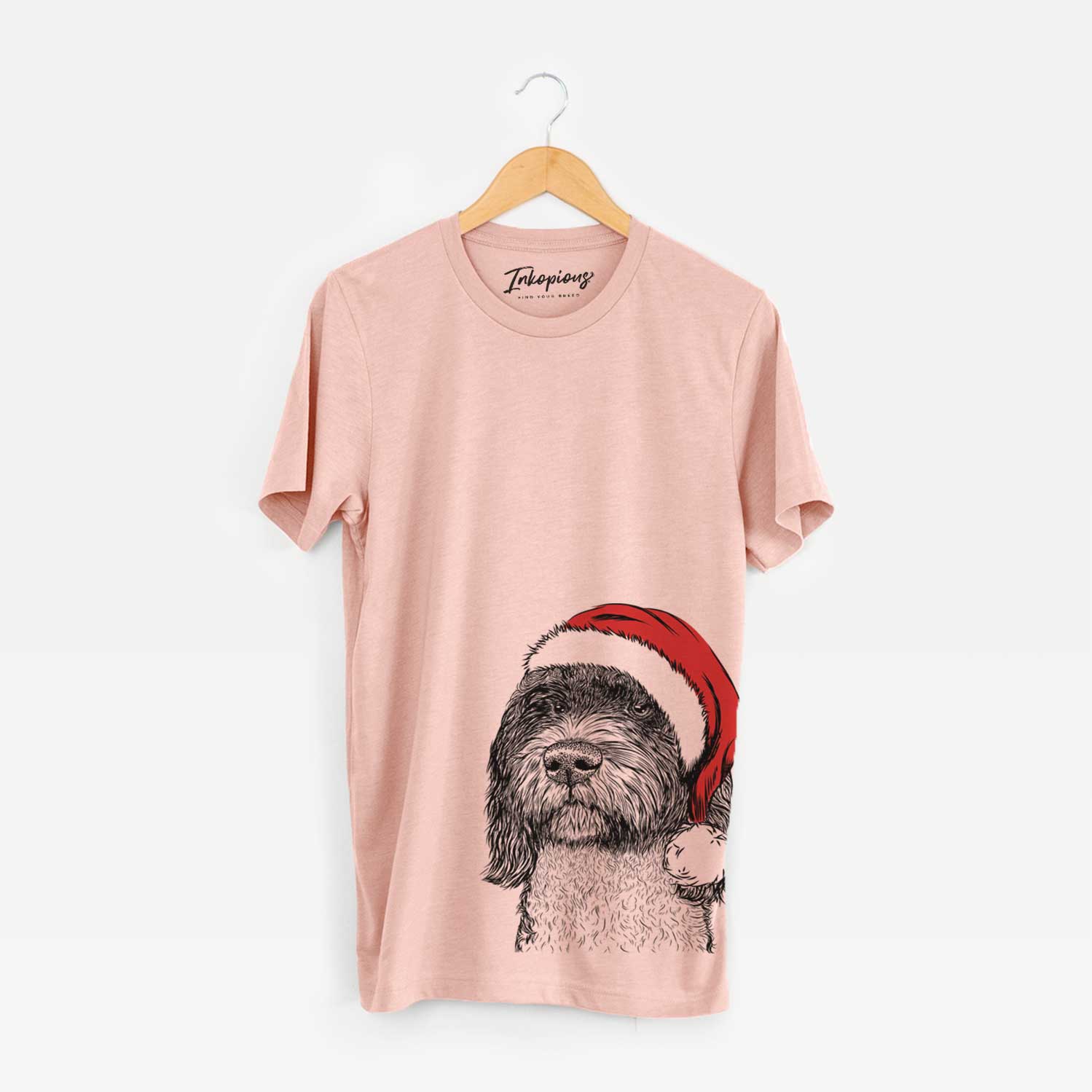 Hand-drawn sketch of Chris the Portuguese Water Dog wearing a Santa hat on a Peach Unisex crewneck