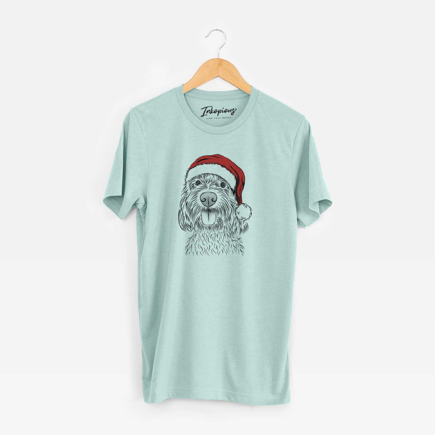 Hand-drawn sketch of Clover the Cockapoo wearing a Santa hat on a Heather Sage Unisex crewneck