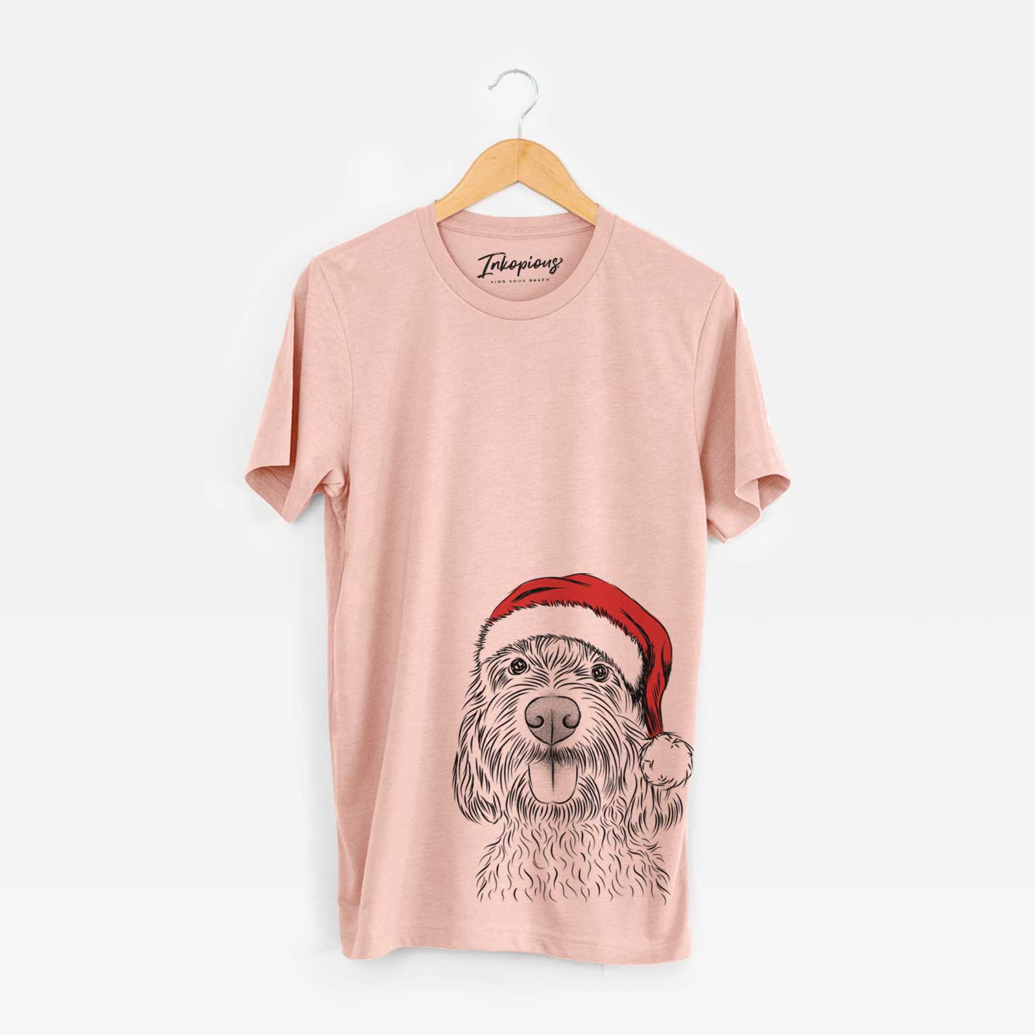 Hand-drawn sketch of Clover the Cockapoo wearing a Santa hat on a Peach Unisex crewneck