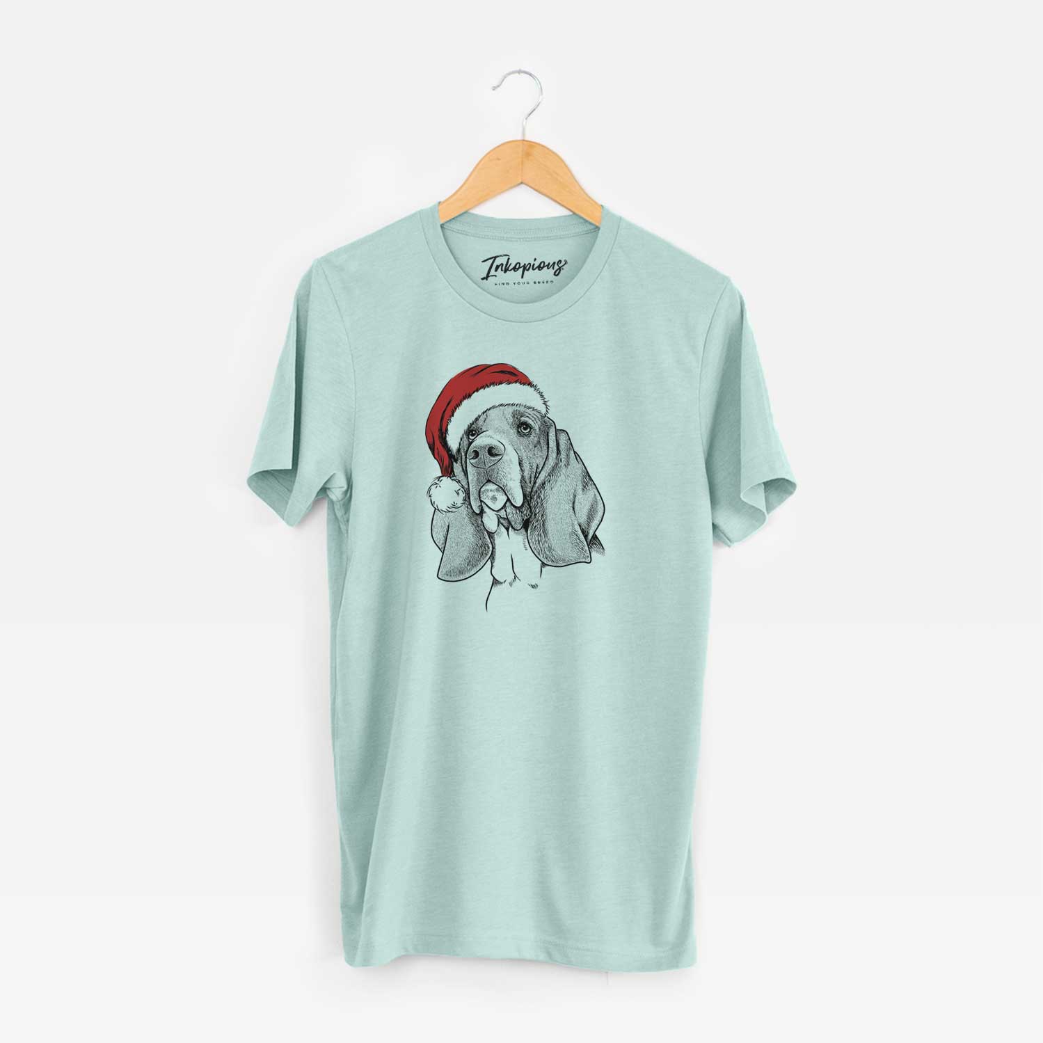 Hand-drawn sketch of Cooper the Basset Hound wearing a Santa hat on a Heather Sage Unisex crewneck