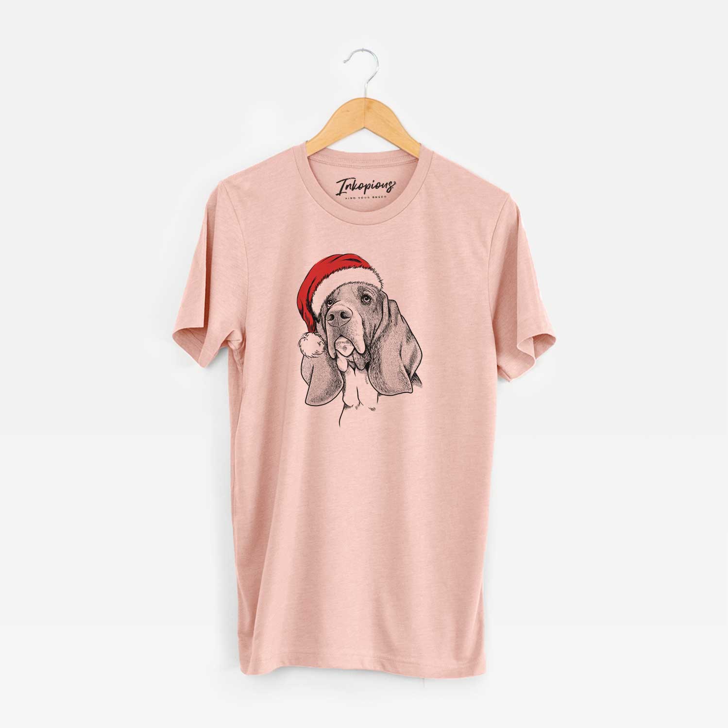 Hand-drawn sketch of Cooper the Basset Hound wearing a Santa hat on a Peach Unisex crewneck