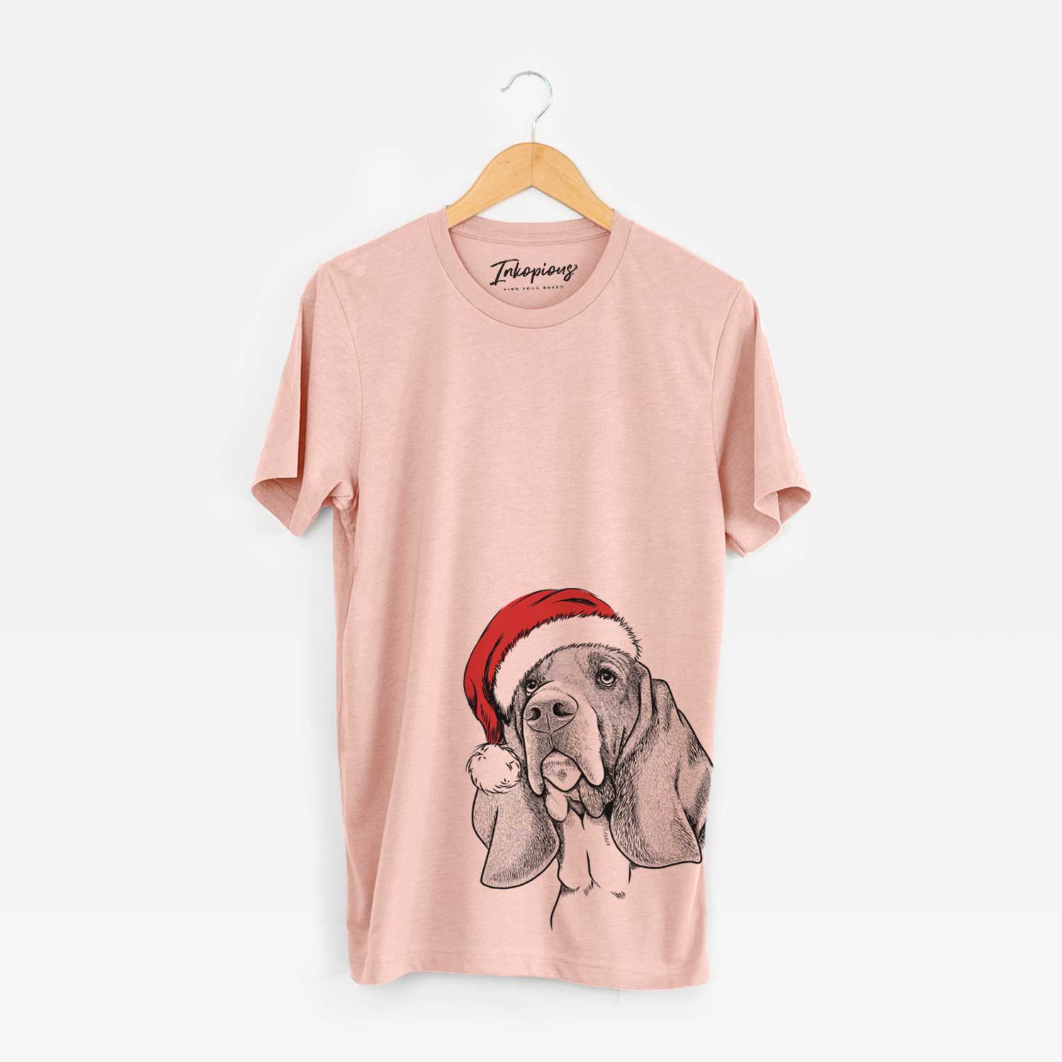 Hand-drawn sketch of Cooper the Basset Hound wearing a Santa hat on a Peach Unisex crewneck