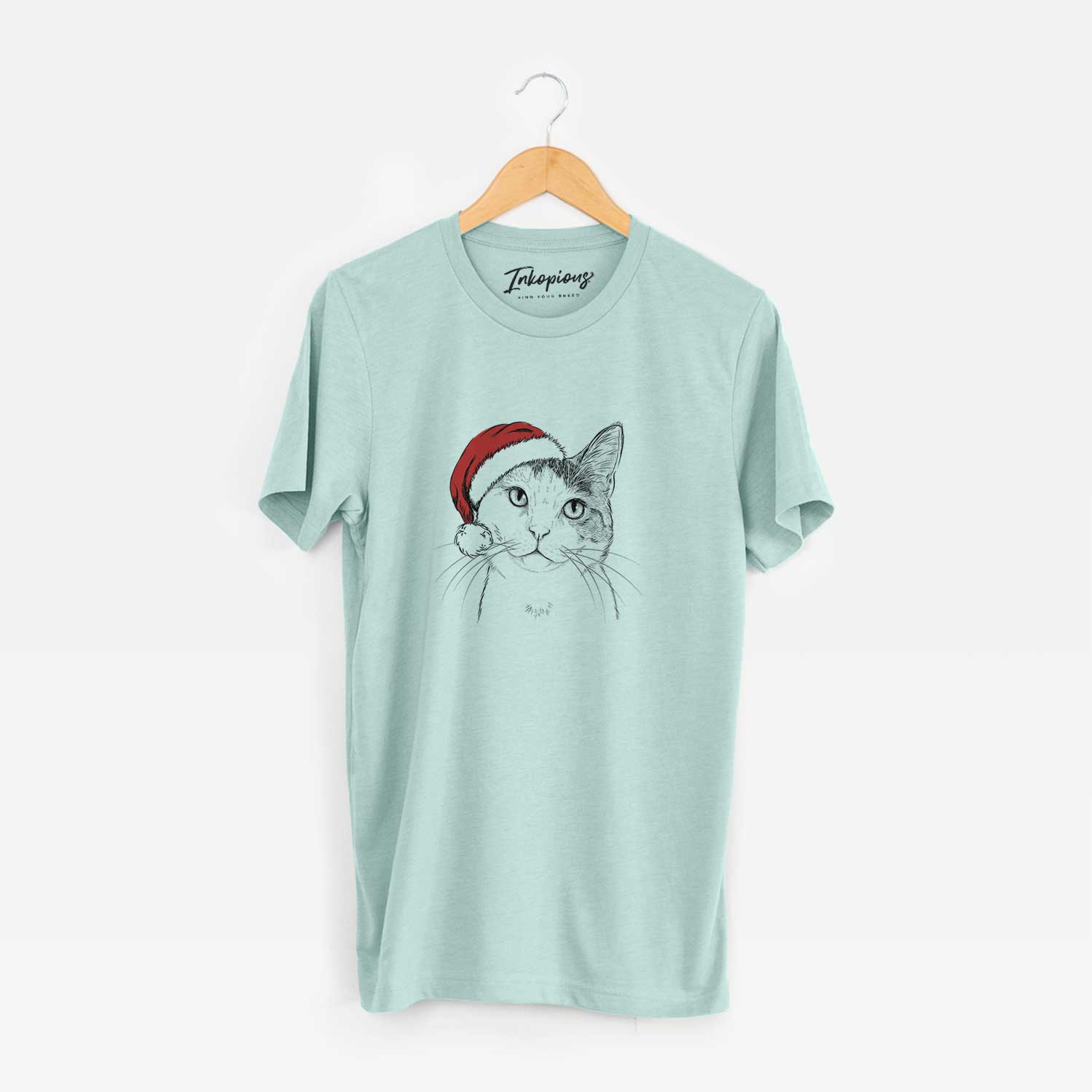 Hand-drawn sketch of Denver the Calico Cat wearing a Santa hat on a Heather Sage Unisex crewneck