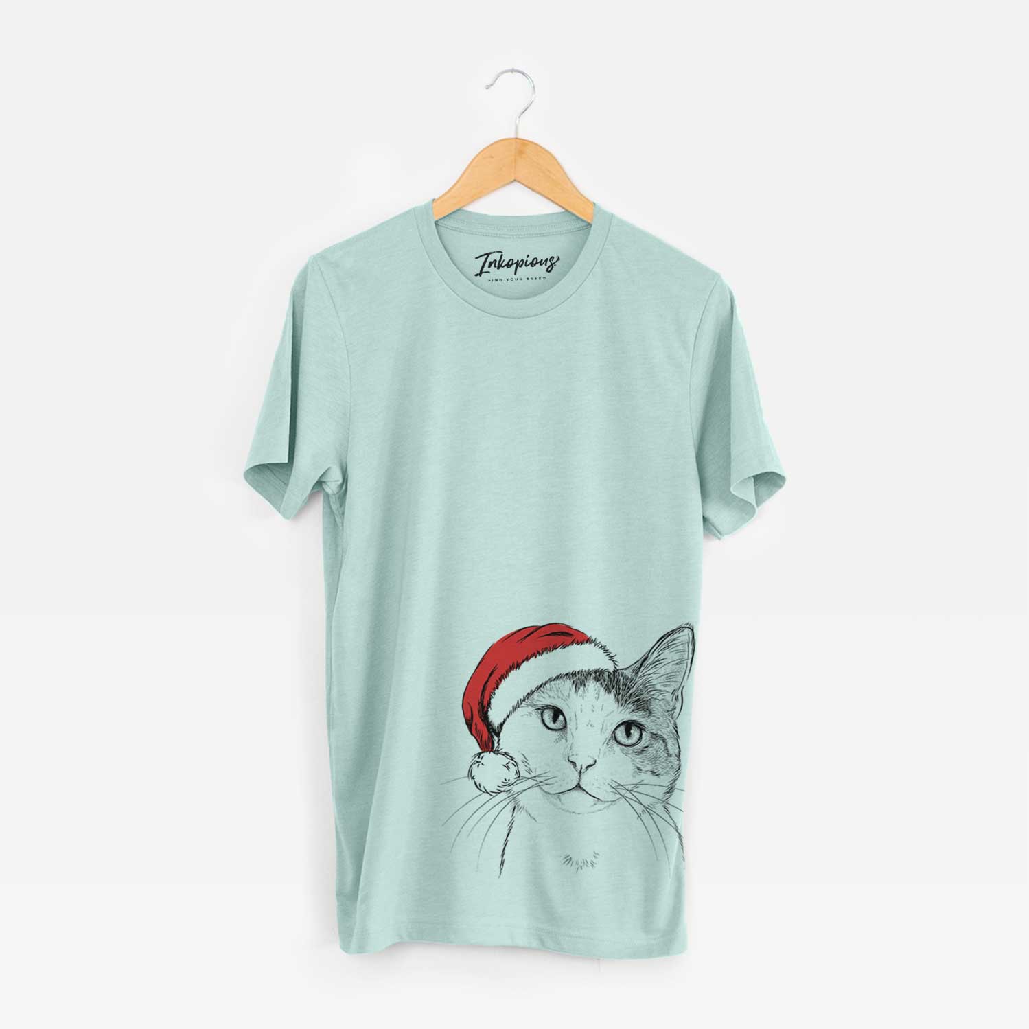 Hand-drawn sketch of Denver the Calico Cat wearing a Santa hat on a Heather Sage Unisex crewneck