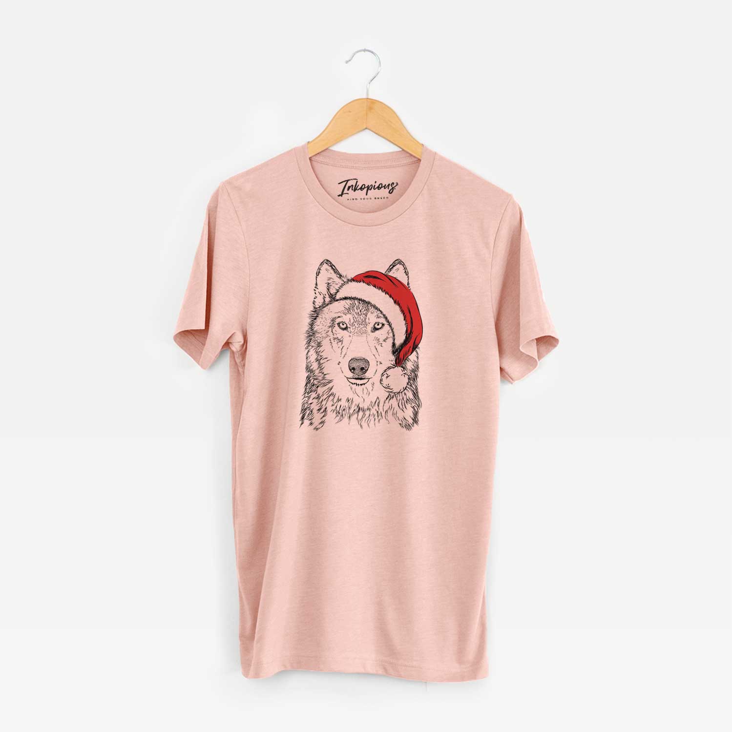 Hand-drawn sketch of Django the Grey Wolf wearing a Santa hat on a Peach Unisex crewneck