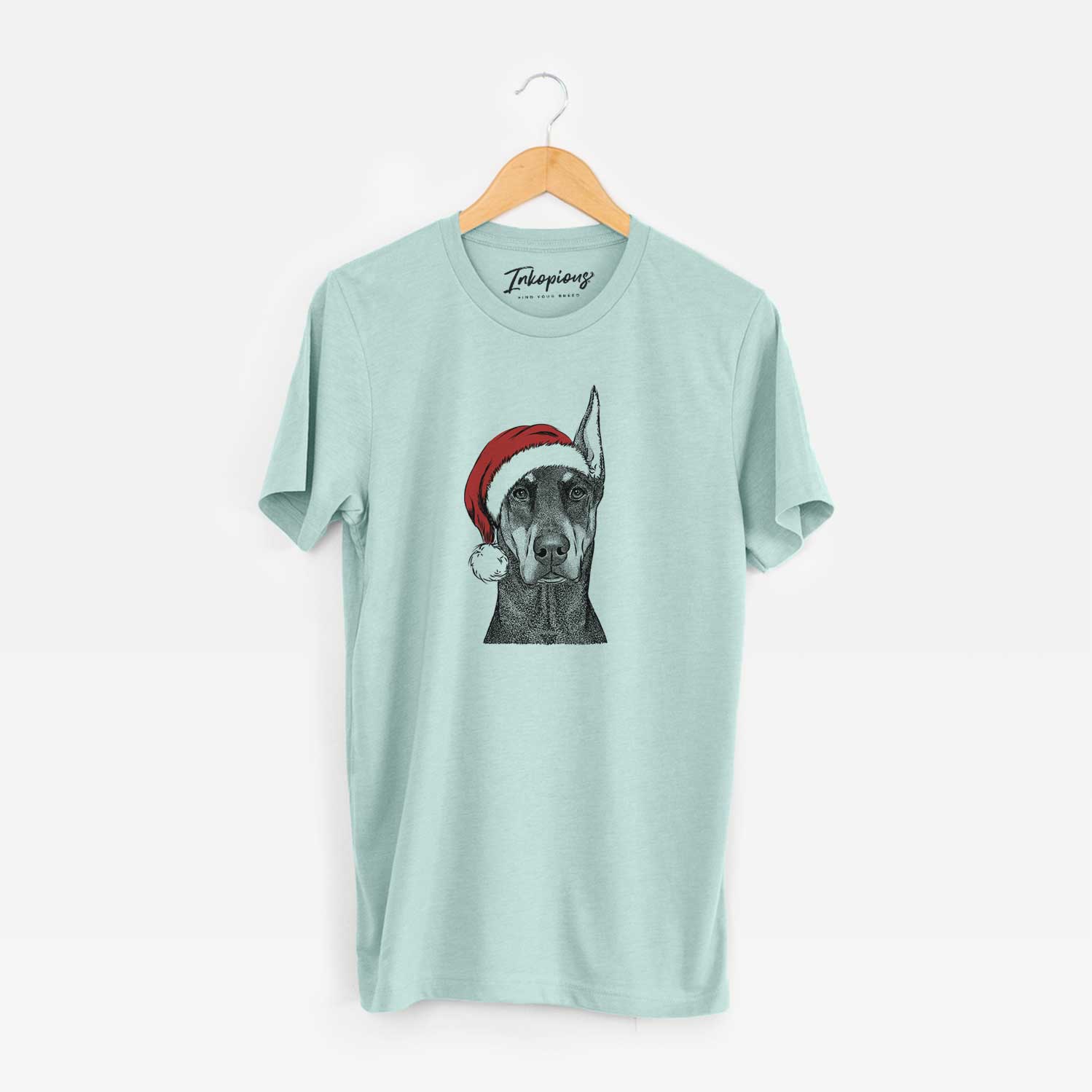 Hand-drawn sketch of Drake the Doberman Pinscher wearing a Santa hat on a Heather Sage Unisex crewneck