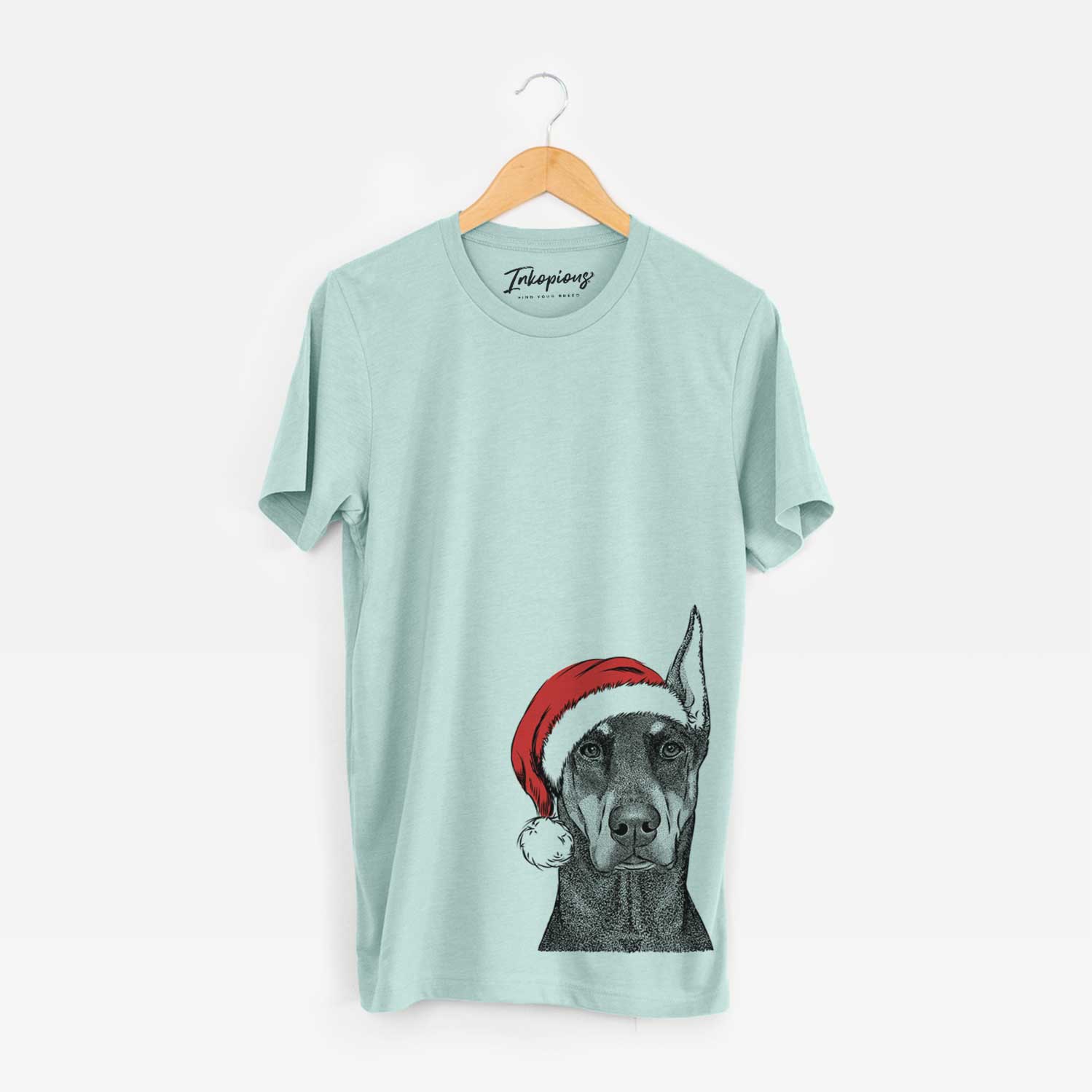 Hand-drawn sketch of Drake the Doberman Pinscher wearing a Santa hat on a Heather Sage Unisex crewneck