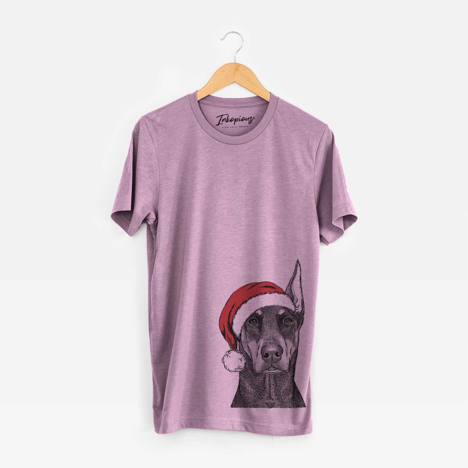 Hand-drawn sketch of Drake the Doberman Pinscher wearing a Santa hat on an Orchid Unisex crewneck