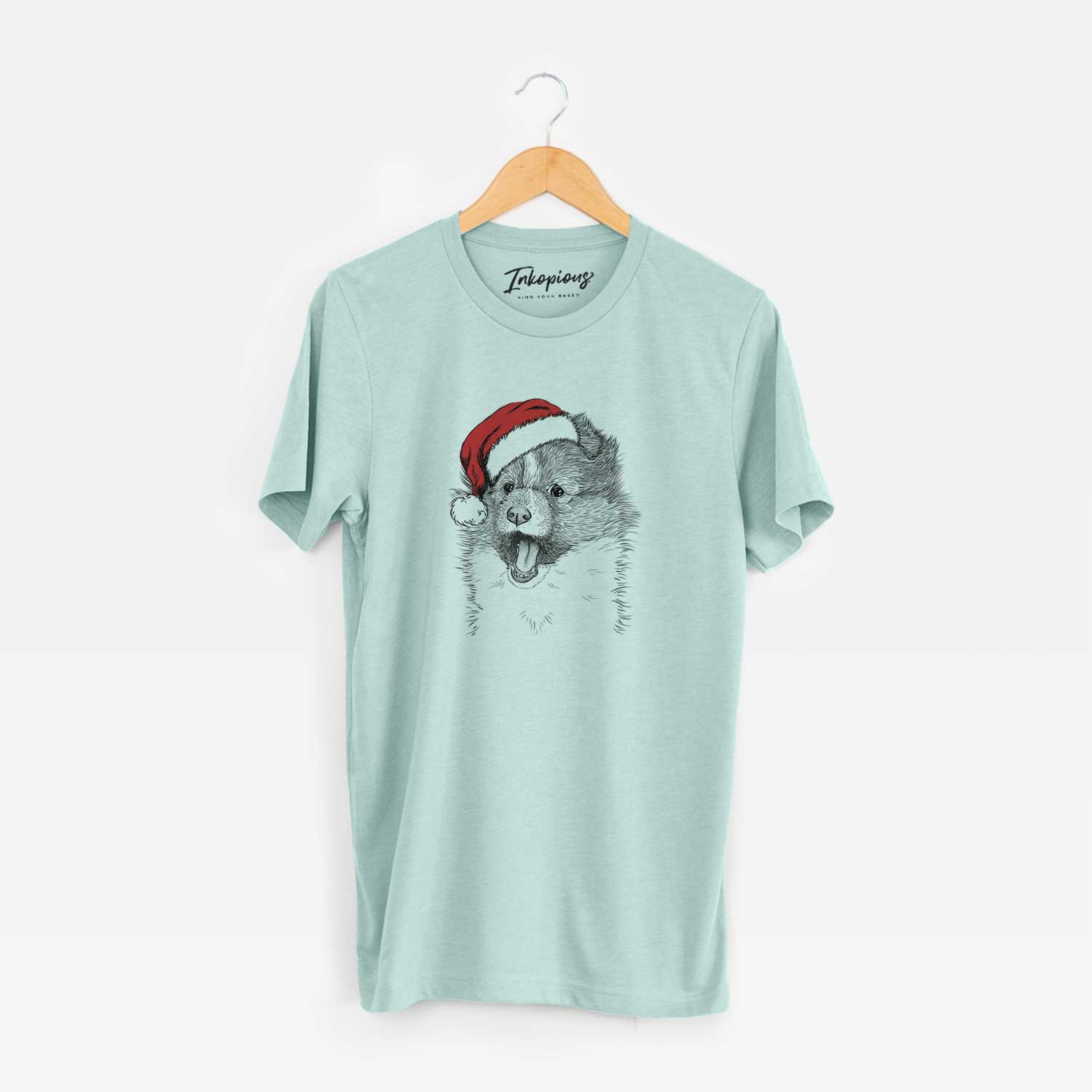 Hand-drawn sketch of Dylan the Shetland Sheepdog wearing a Santa hat on a Heather Sage Unisex crewneck