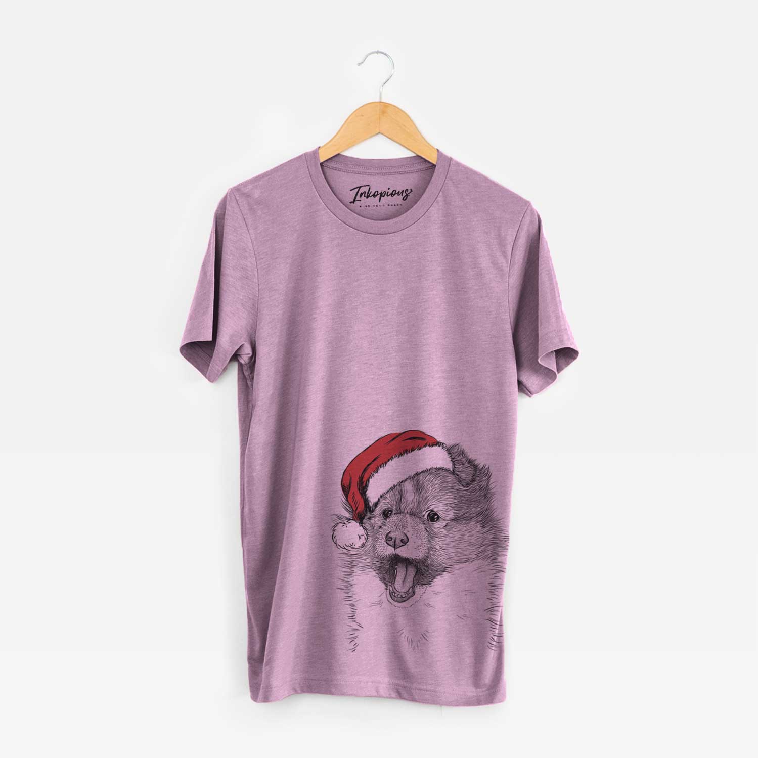 Hand-drawn sketch of Dylan the Shetland Sheepdog wearing a Santa hat on an Orchid Unisex crewneck