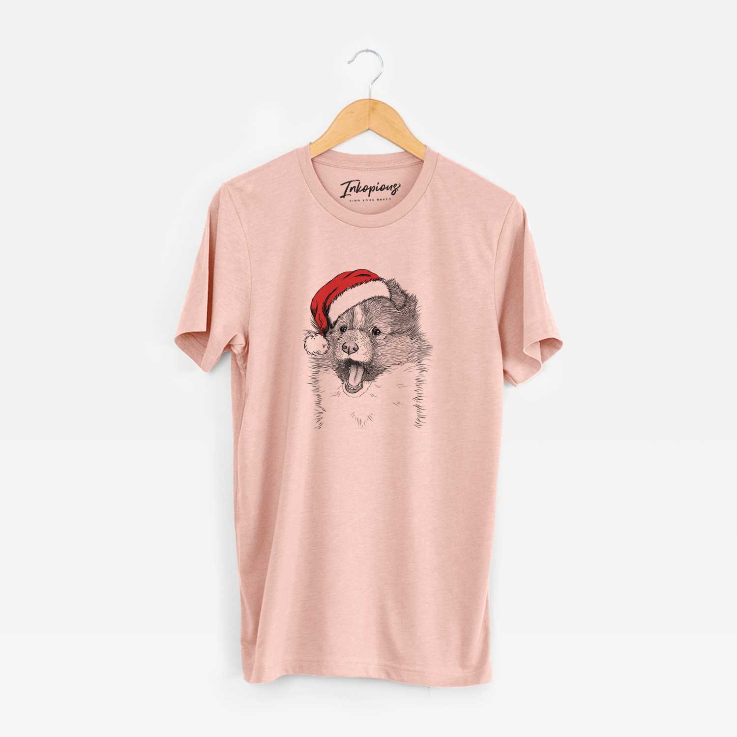 Hand-drawn sketch of Dylan the Shetland Sheepdog wearing a Santa hat on a Peach Unisex crewneck