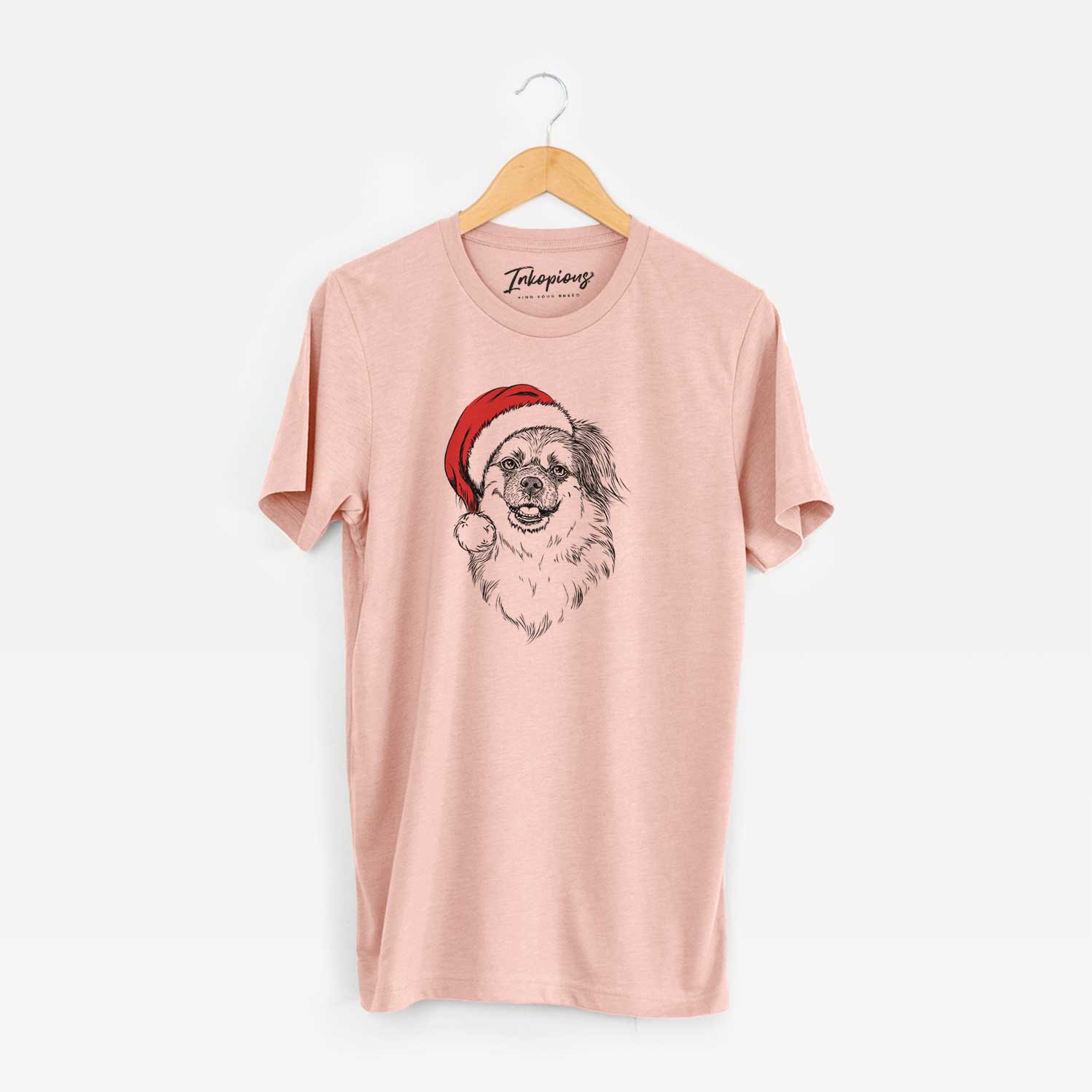Hand-drawn sketch of Ed the Tibetan Spaniel wearing a Santa hat on a Peach Unisex crewneck