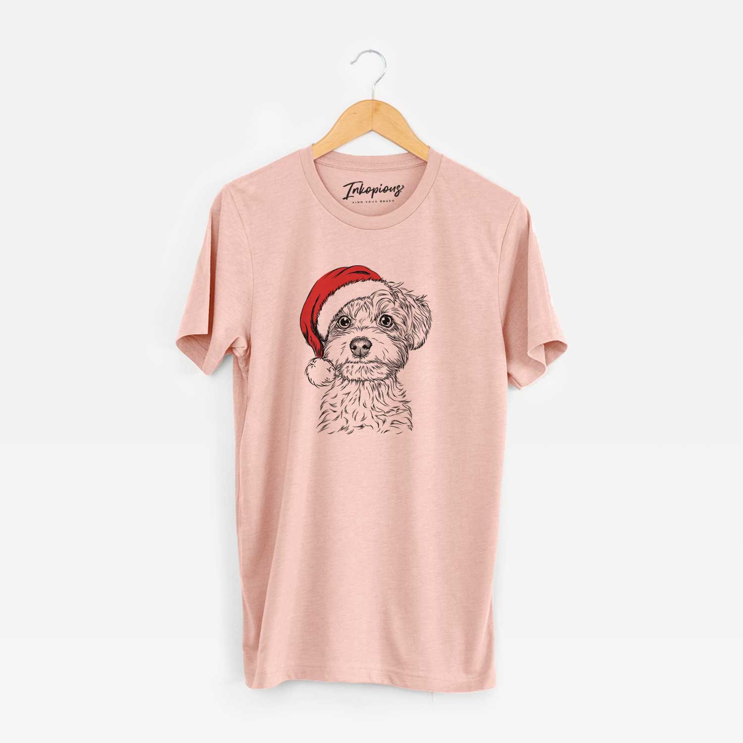Hand-drawn sketch of Elliott the Yorkiepoo wearing a Santa hat on a Peach Unisex crewneck