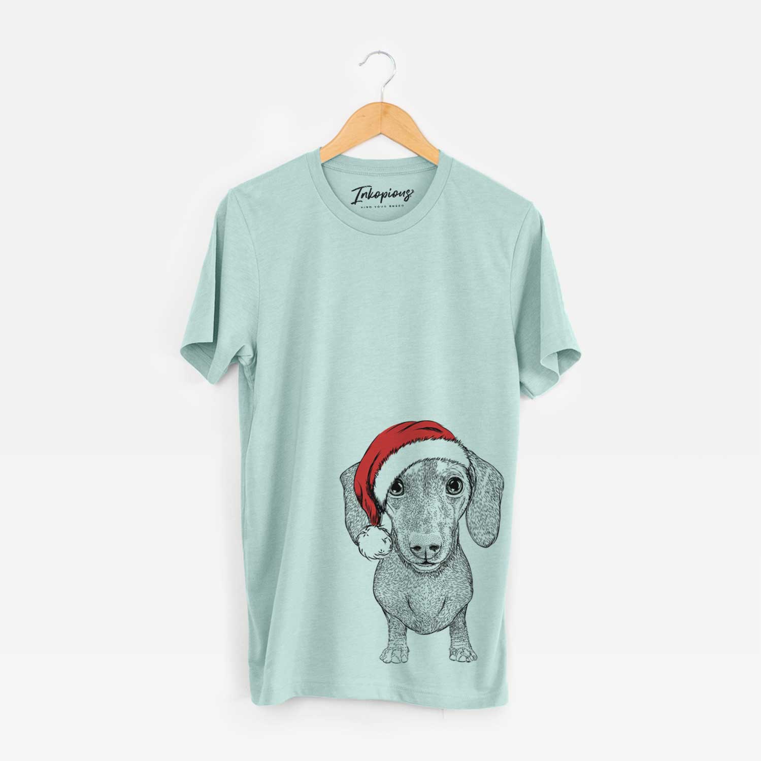 Hand-drawn sketch of Ernie the Mini Dachshund wearing a Santa hat on a Heather Sage Unisex crewneck