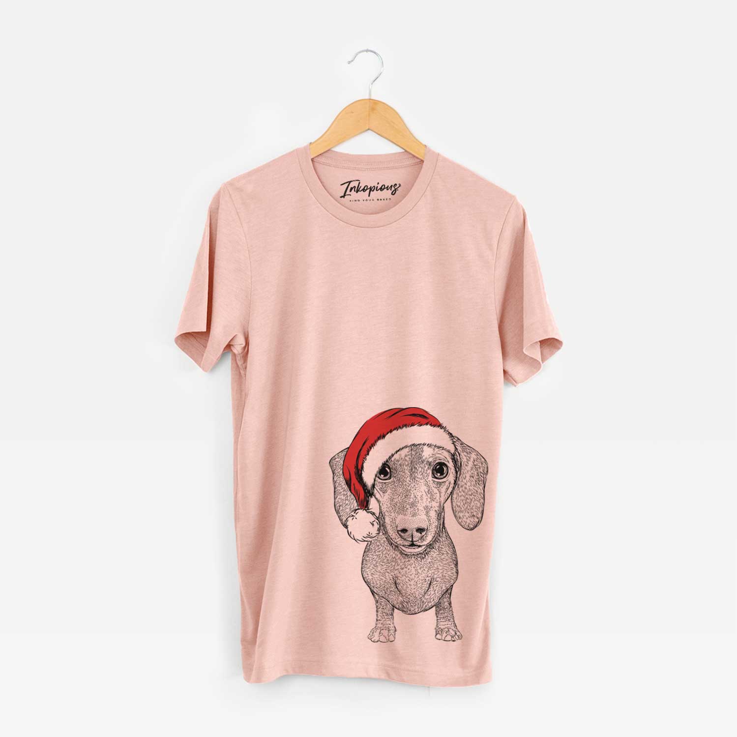 Hand-drawn sketch of Ernie the Mini Dachshund wearing a Santa hat on a Peach Unisex crewneck