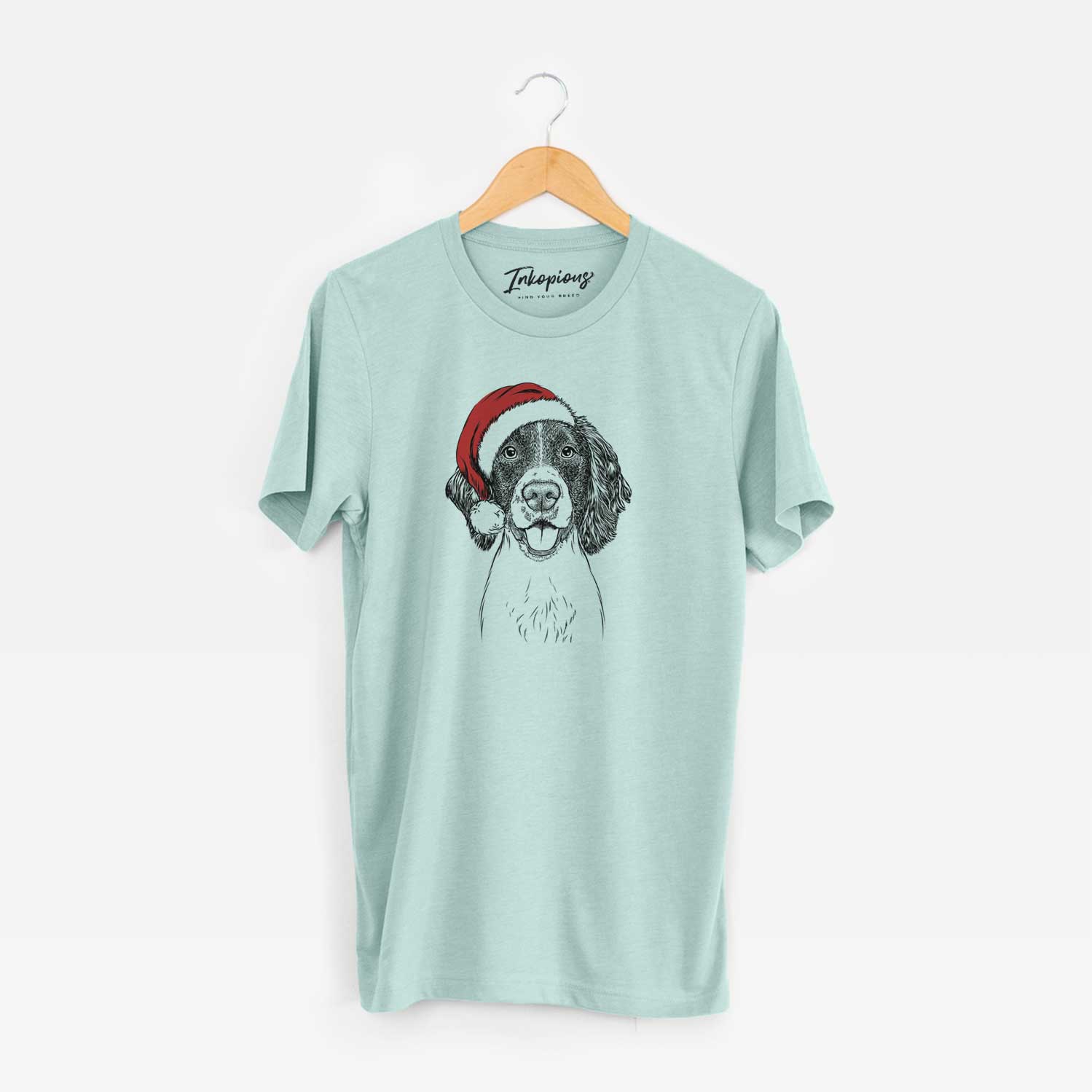 Hand-drawn sketch of Ever the English Springer Spaniel wearing a Santa hat on a Heather Sage Unisex crewneck