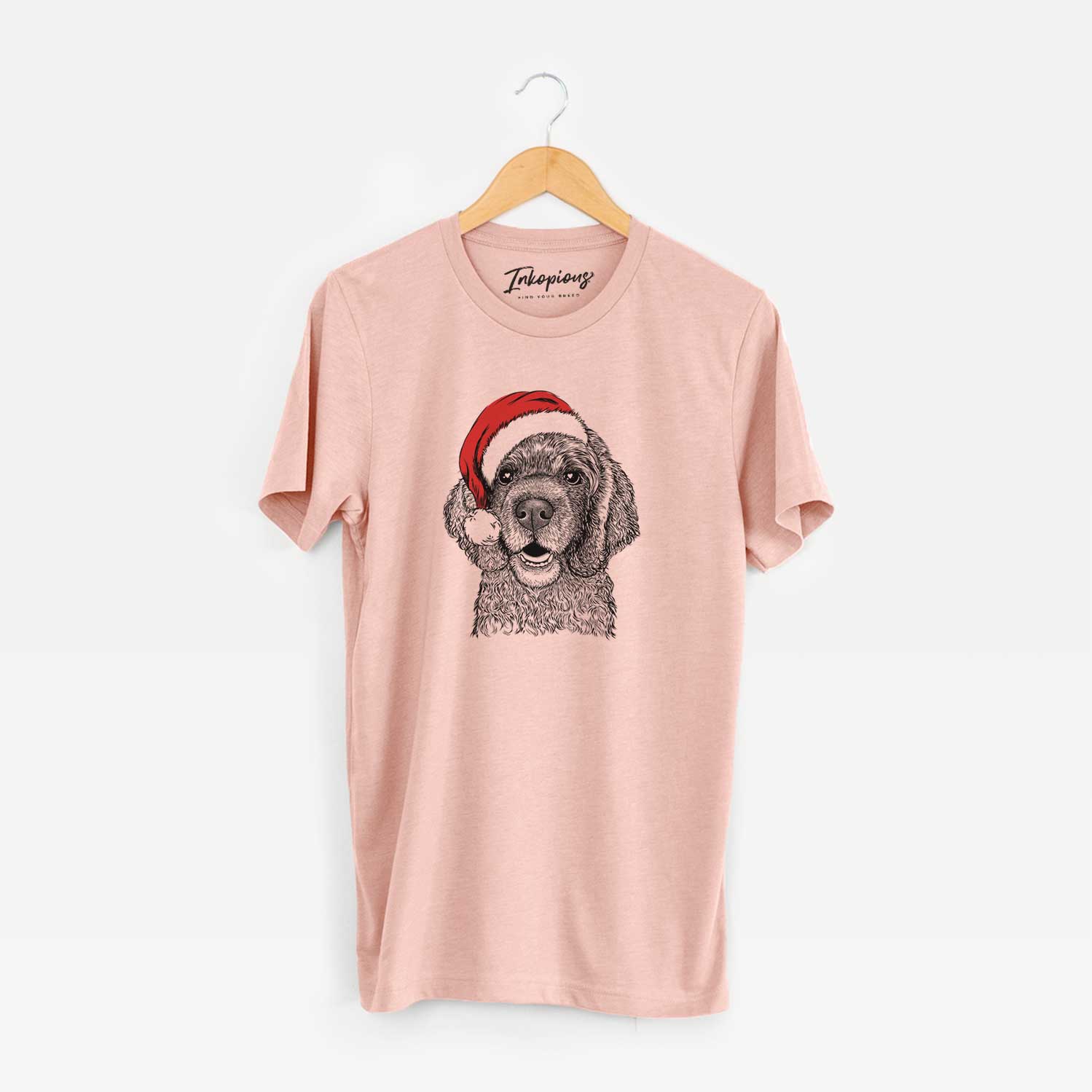 Hand-drawn sketch of Fannie Mae the Cocker Spaniel wearing a Santa hat on a Peach Unisex crewneck
