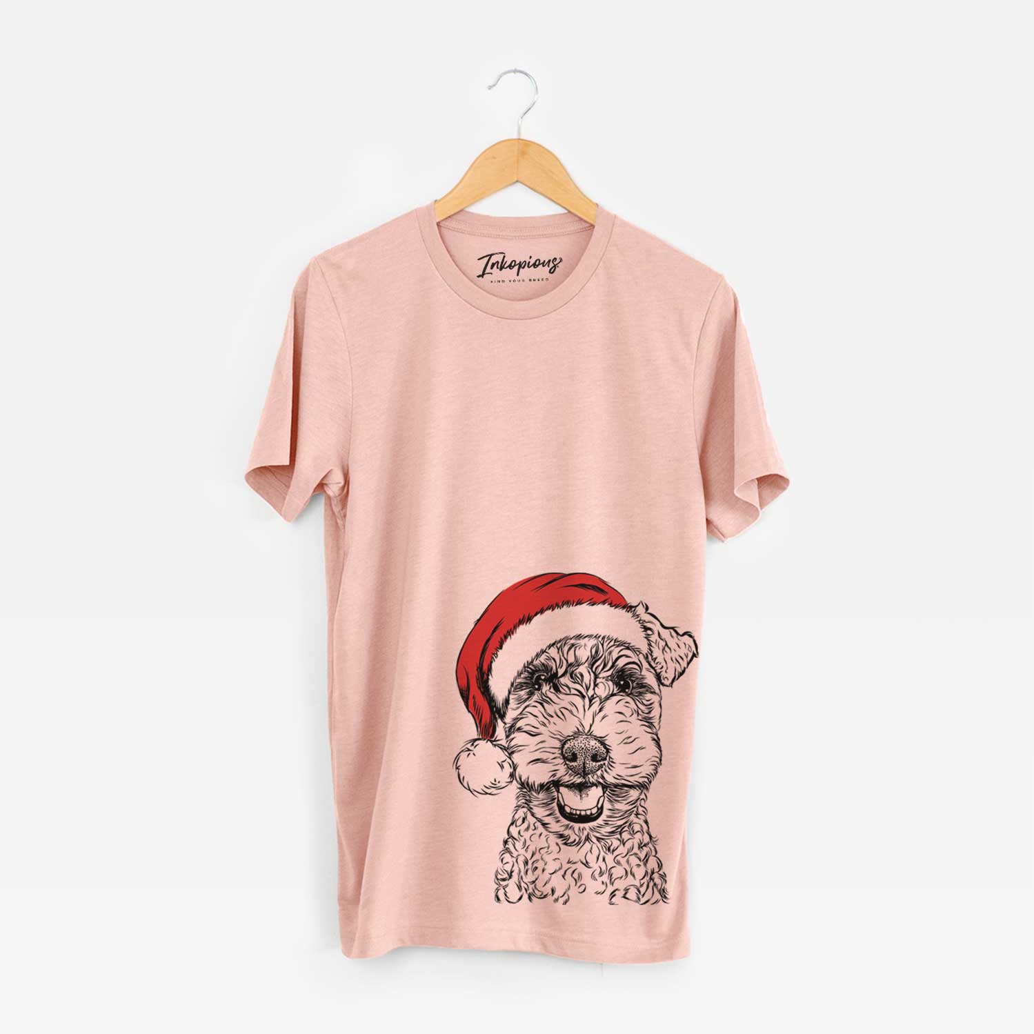 Hand-drawn sketch of Fintan the Irish Troodle wearing a Santa hat on a Peach Unisex crewneck