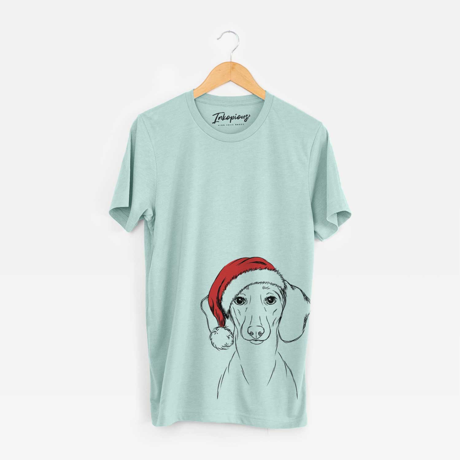 Hand-drawn sketch of Hans the Dachshund wearing a Santa hat on a Heather Sage Unisex crewneck