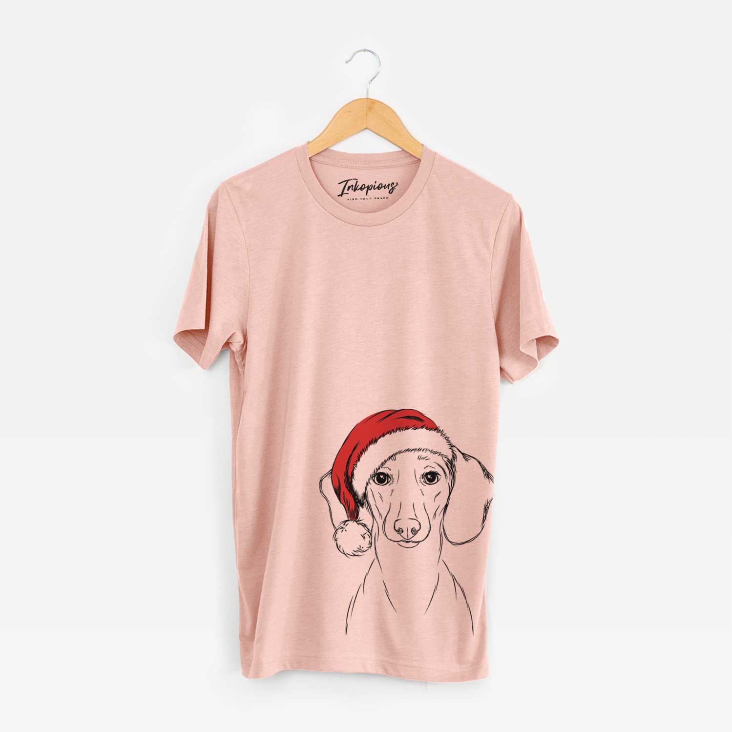 Hand-drawn sketch of Hans the Dachshund wearing a Santa hat on a Peach Unisex crewneck