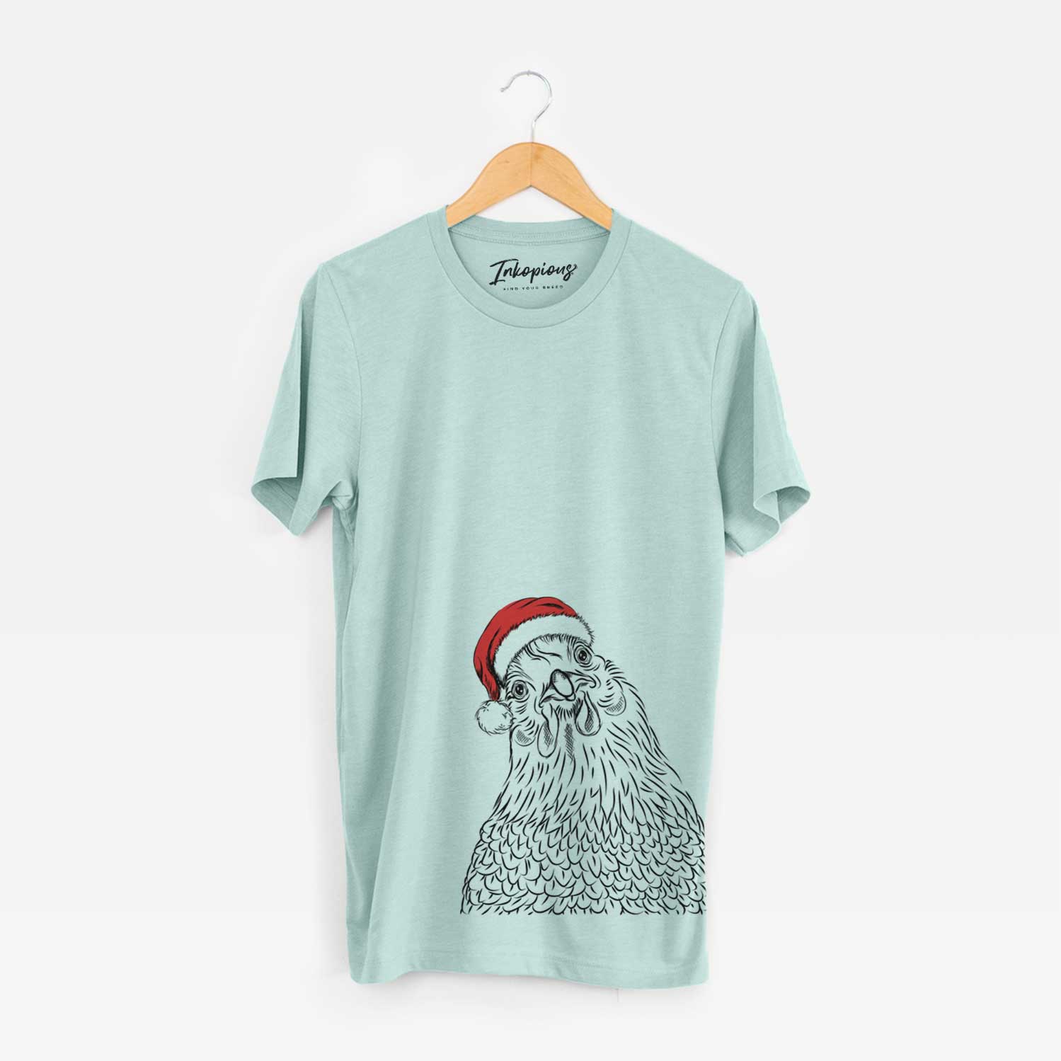 Hand-drawn sketch of Henrietta the Chicken wearing a Santa hat on a Heather Sage Unisex crewneck