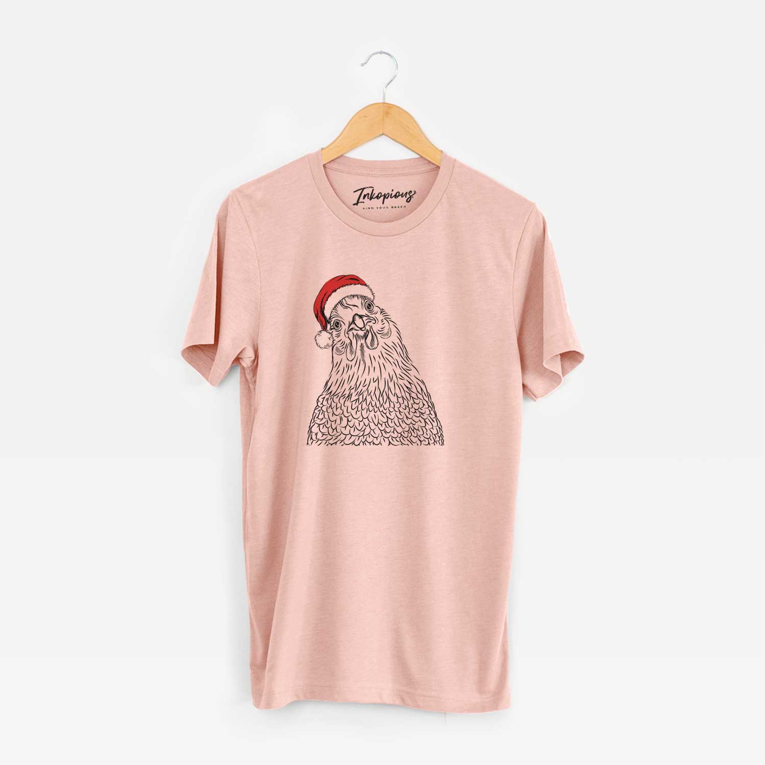 Hand-drawn sketch of Henrietta the Chicken wearing a Santa hat on a Peach Unisex crewneck