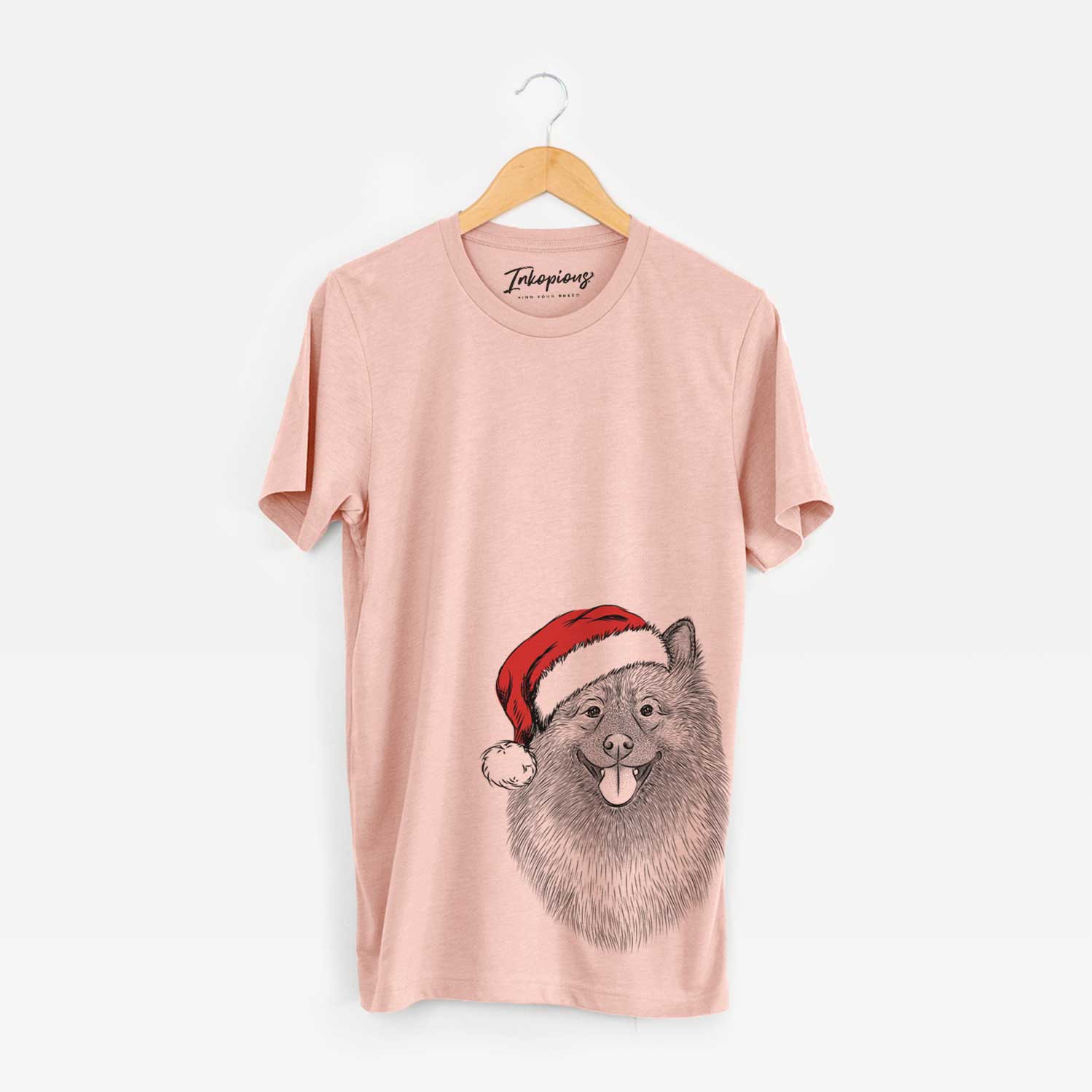 Hand-drawn sketch of Kai the Keeshond wearing a Santa hat on a Peach Unisex crewneck