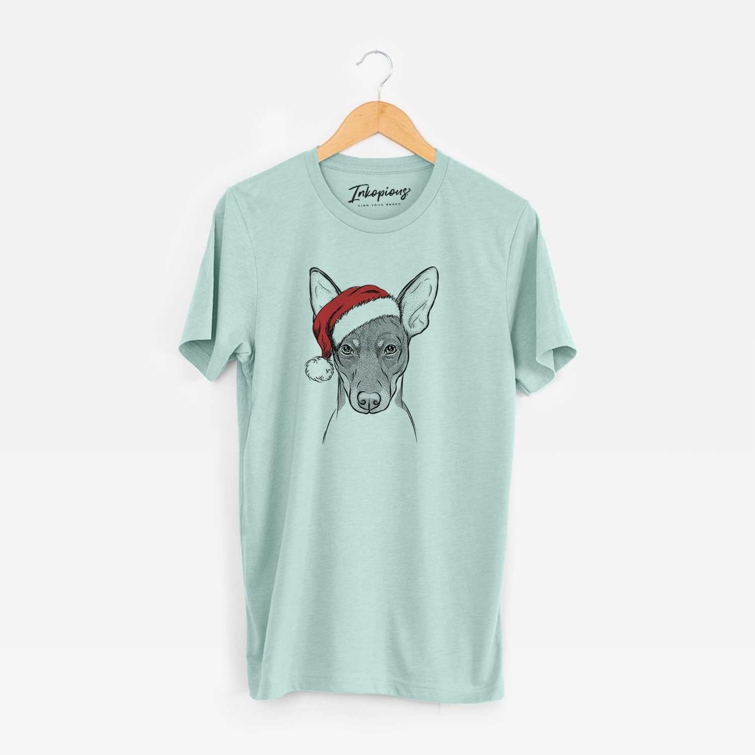 Hand-drawn sketch of Knox the Rat Terrier wearing a Santa hat on a Heather Sage Unisex crewneck