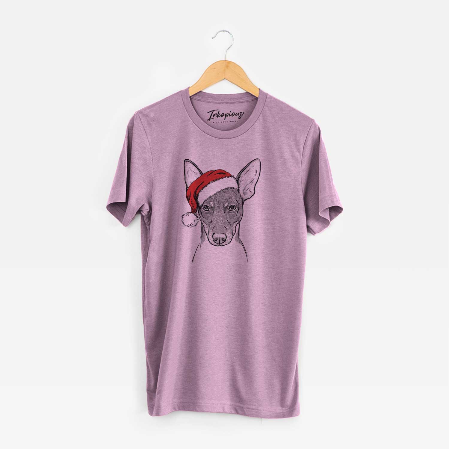 Hand-drawn sketch of Knox the Rat Terrier wearing a Santa hat on an Orchid Unisex crewneck
